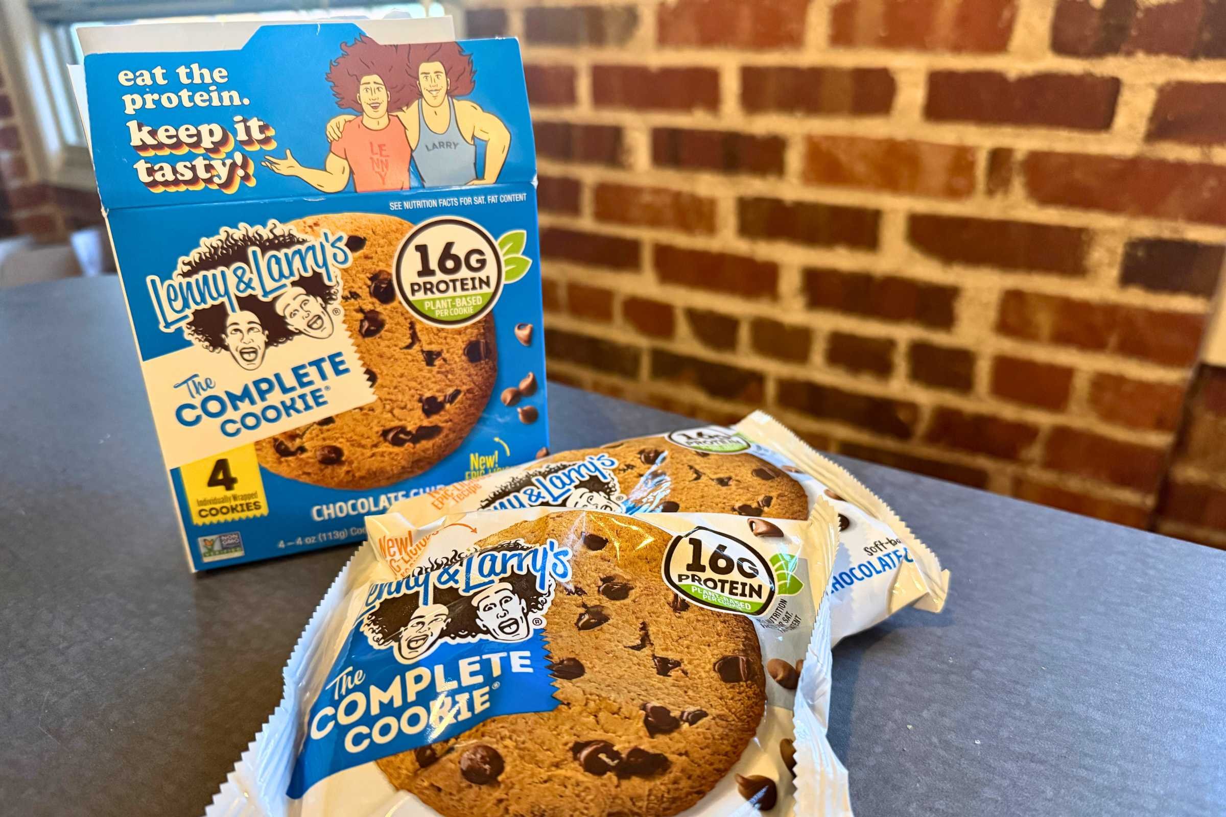 a box of lenny & larry’s complete cookies with two packaged cookies in front of the box