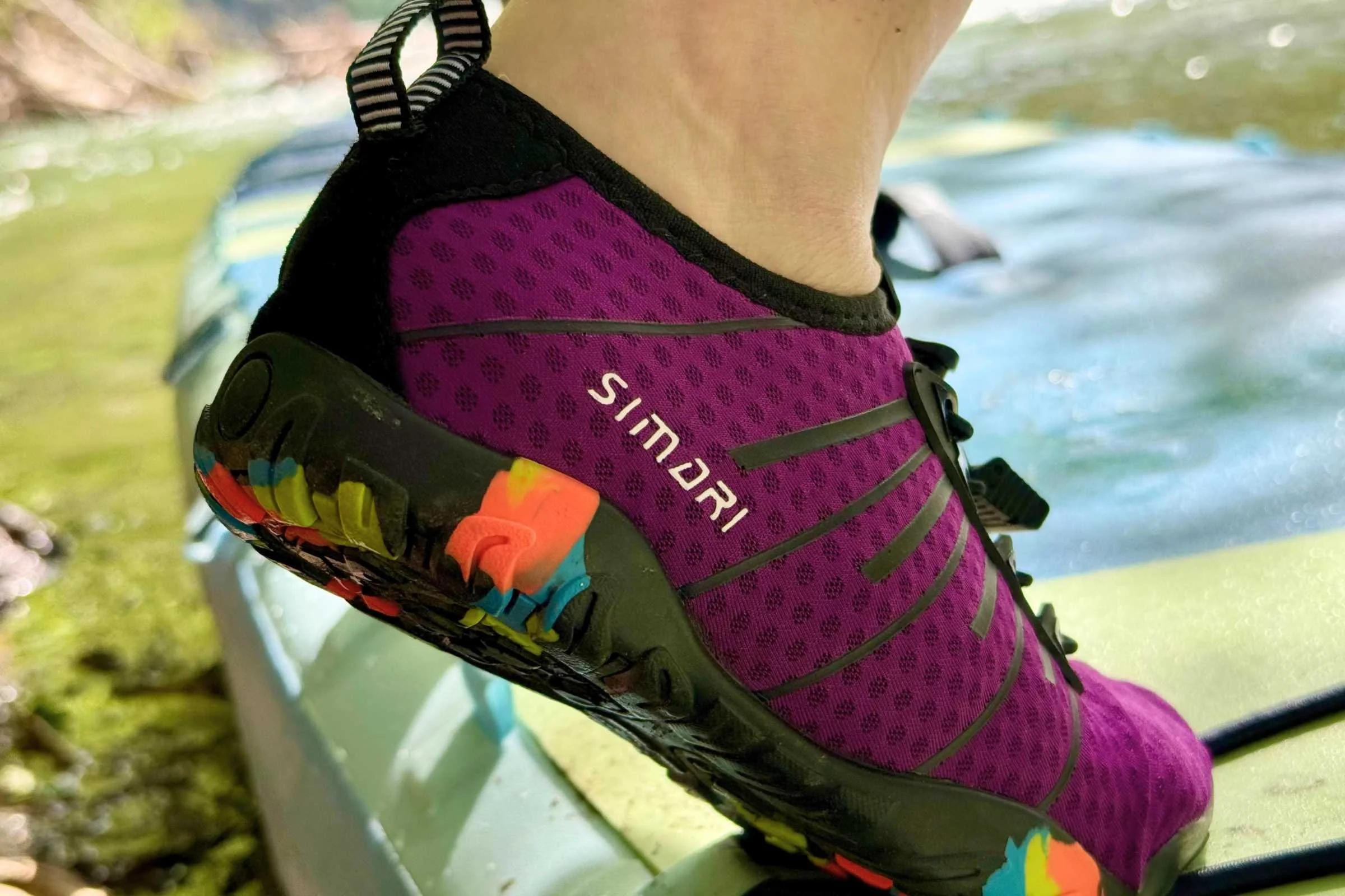 the simari water shoes in purple with a multi-colored sole