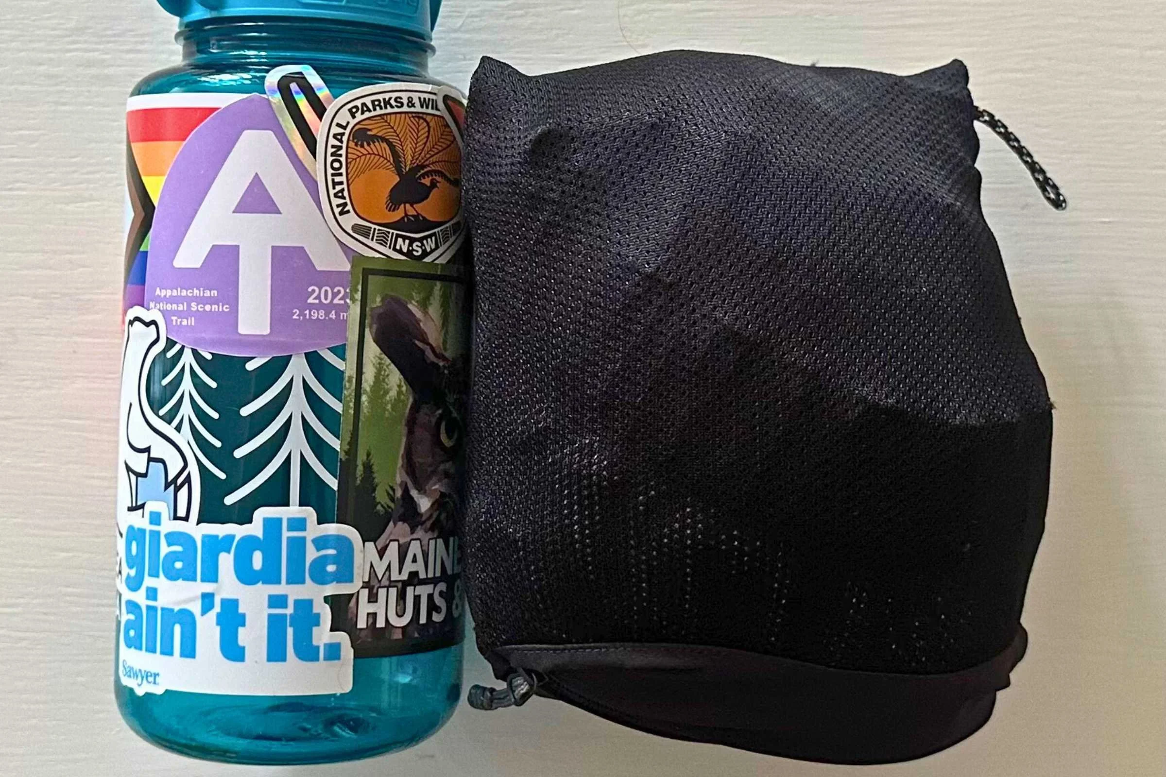 Outdoor Research Foray 3L rain pants packed next to water bottle