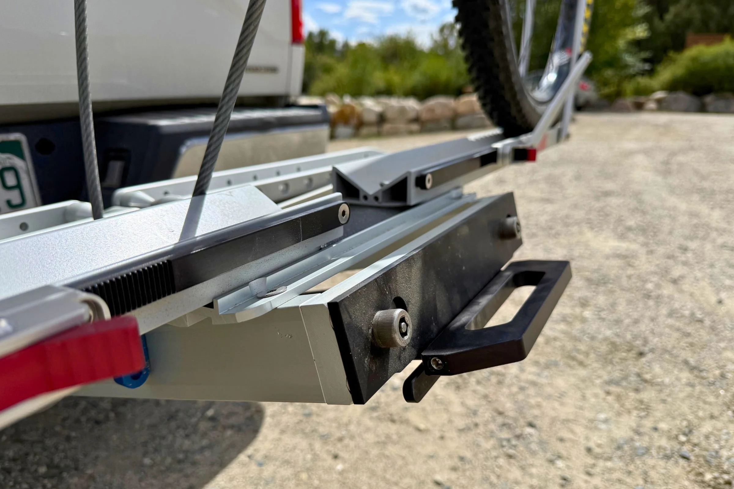 1UP USA Heavy Duty Hitch Bike Rack attached to the back of a truck with a bicycle mounted, highlighting the EZ-pull handle.