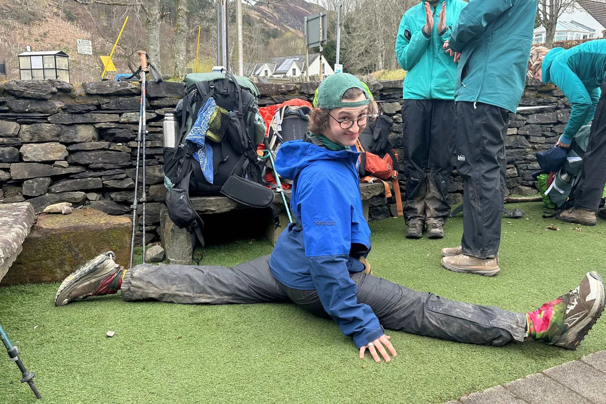 Author doing a front split on astroturf in front of a village store on the West Highland Way.