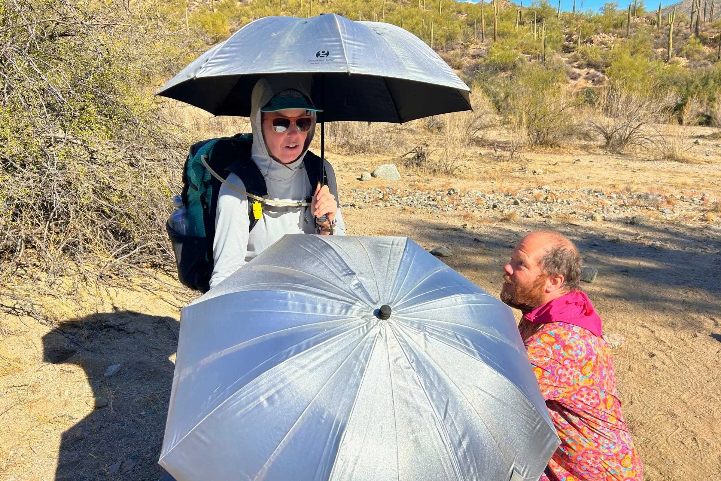 Hikers testing different hiking umbrellas
