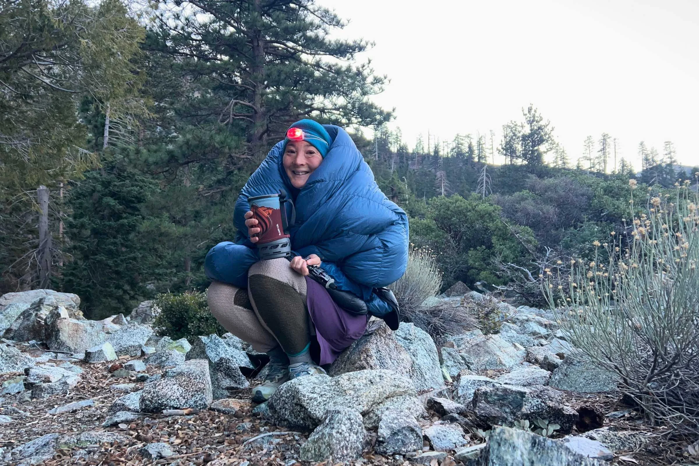 Outdoor Vitals StormLoft 15 Down TopQuilt — woman sitting on rocks