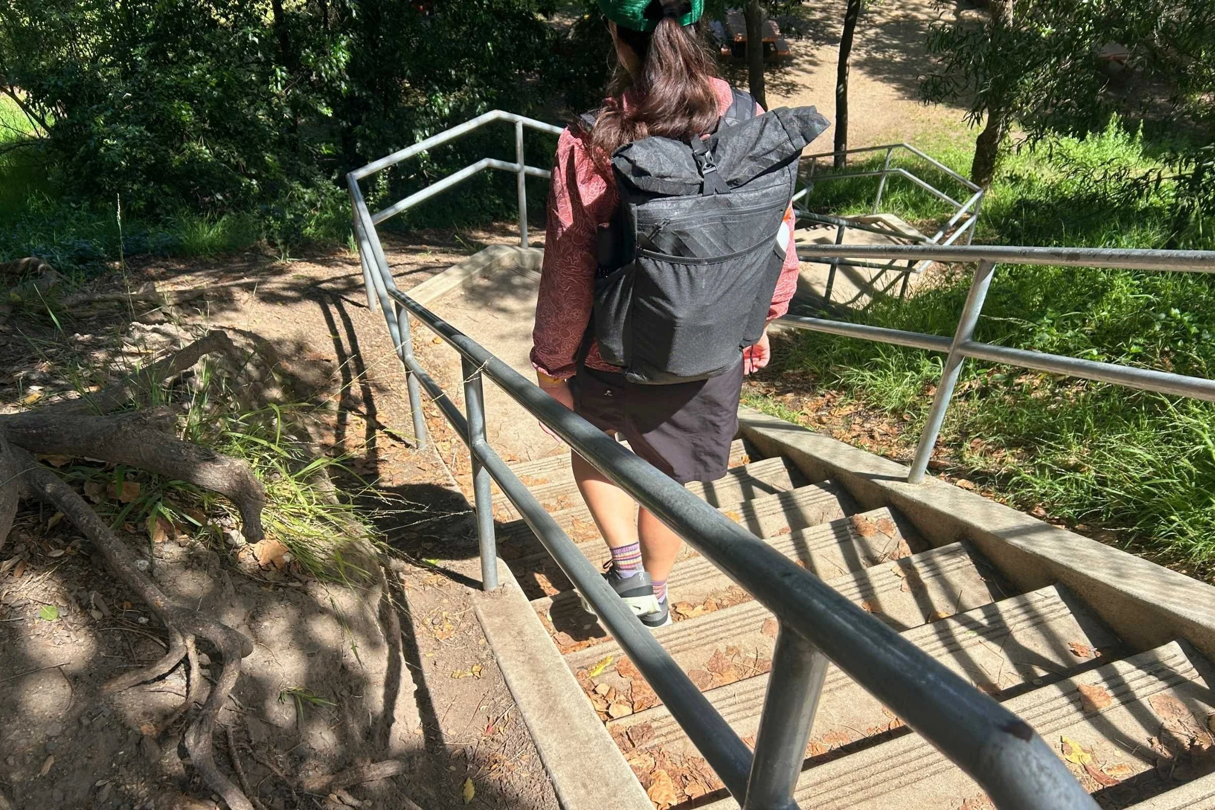 author wearing the ula ultra node 20l backpack walking down a staircase in the sun