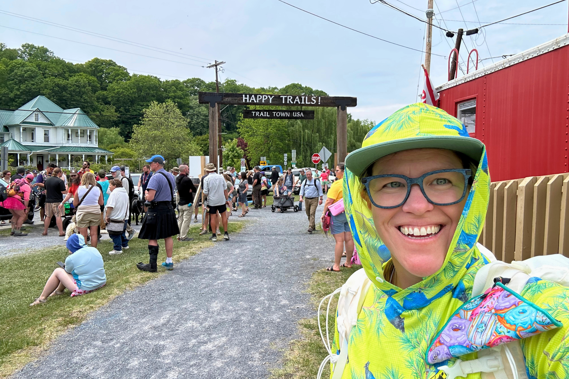 Treeline writer at AT Trail days with the "Happy Trails! Trail Town USA" sign inthe background.
