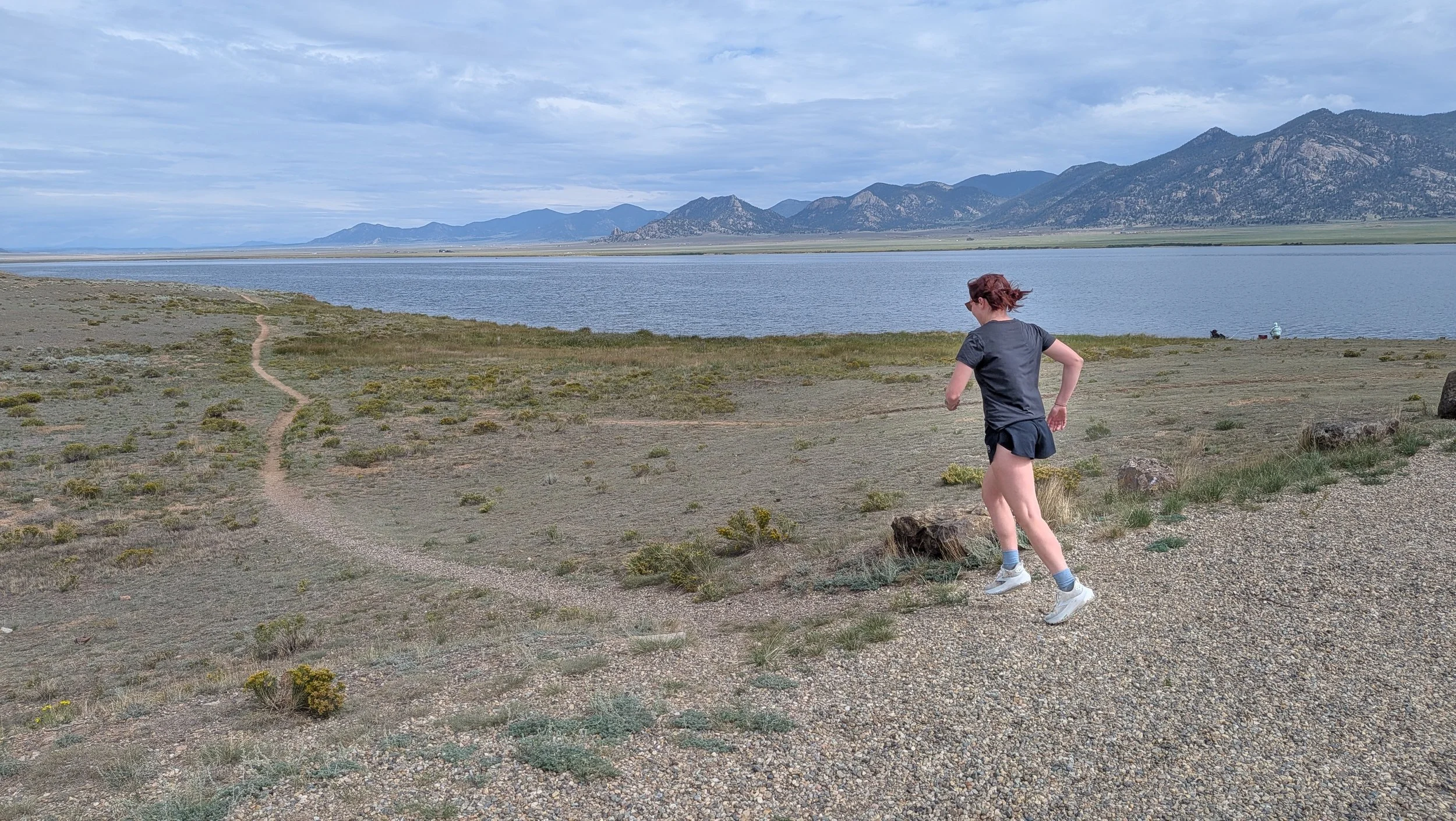 Woman running in Brooks Ghost trail running shoes on gravel.