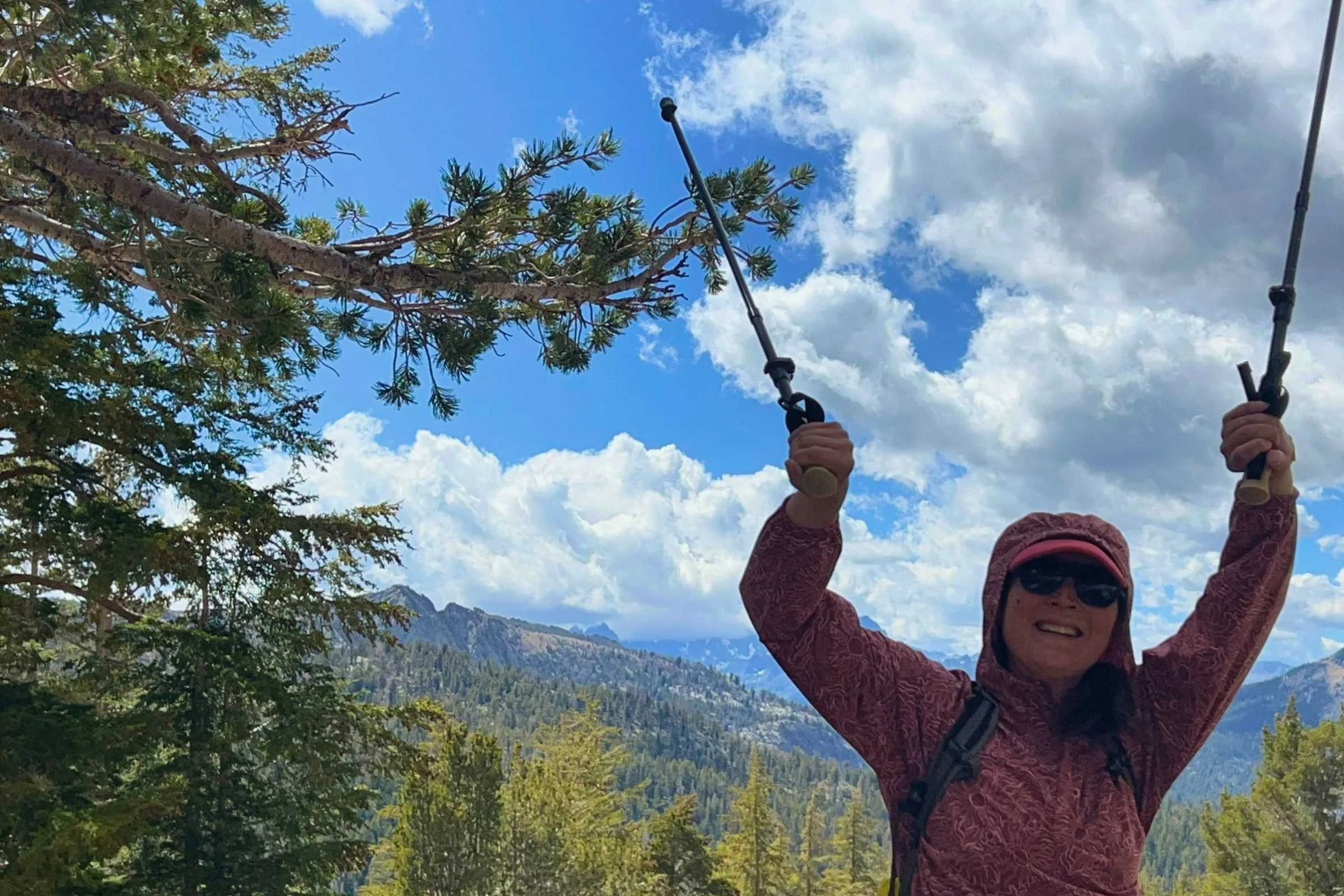 The author hiking with the Gossamer Gear FT3 trekking poles with mountains and trees in the background