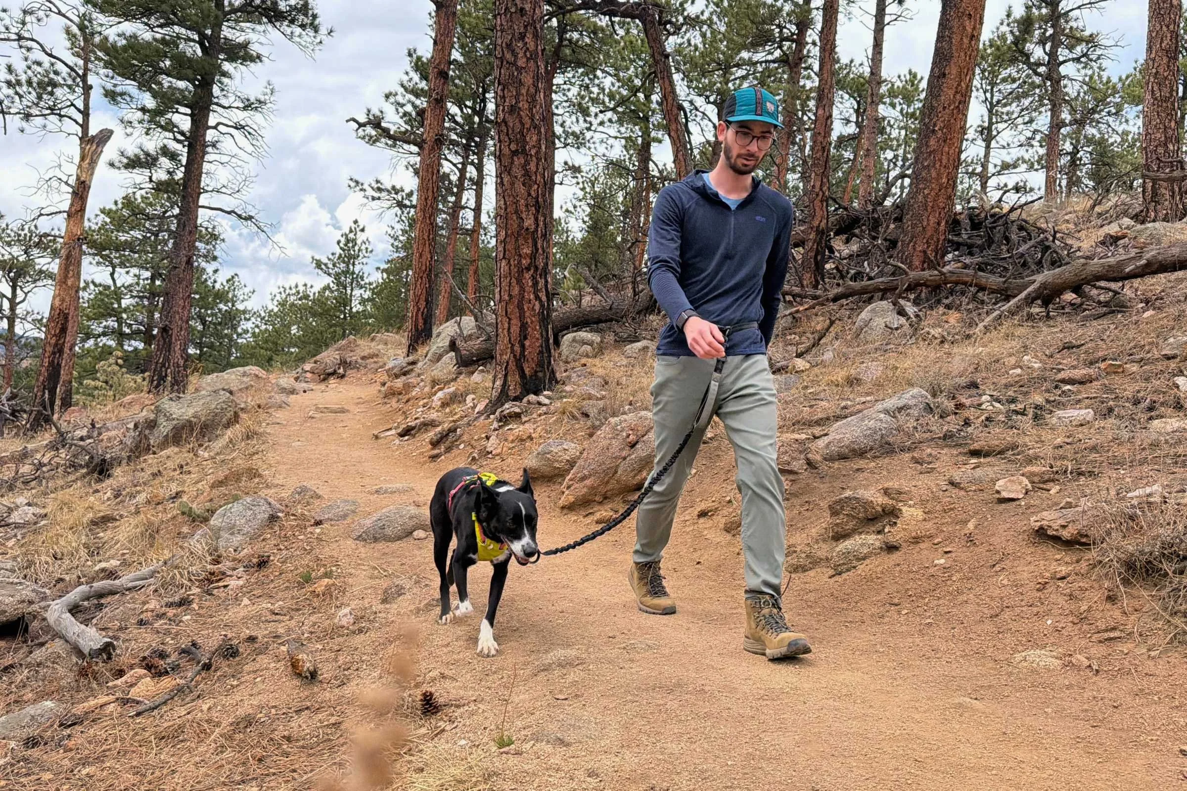 Dog hooked to a Sparklypets hands free leash and man walking on a wooded trail