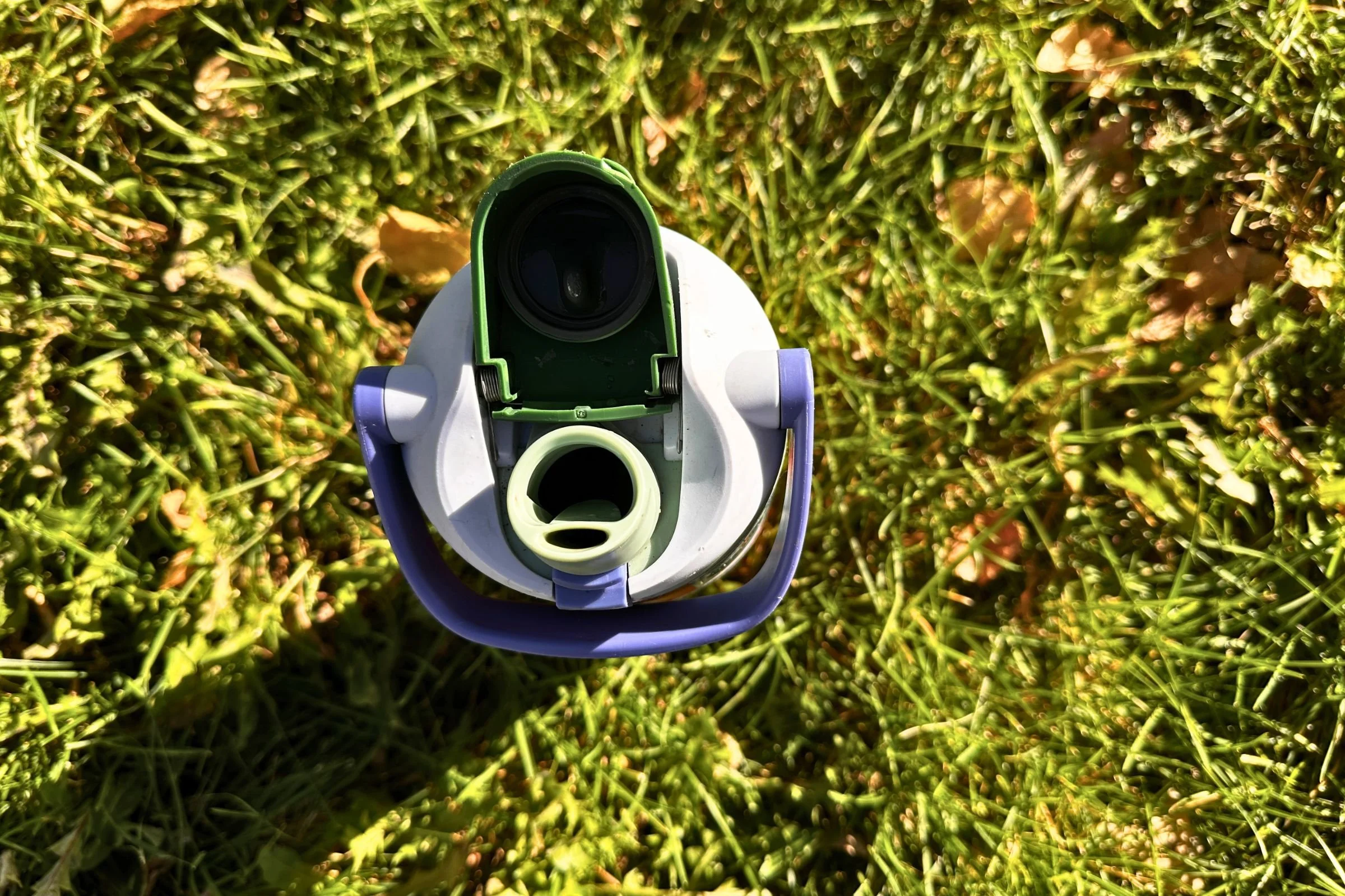 The drinking spout of the FreeSip Sway is open, displaying the smaller opening for sipping and the larger opening for chugging.