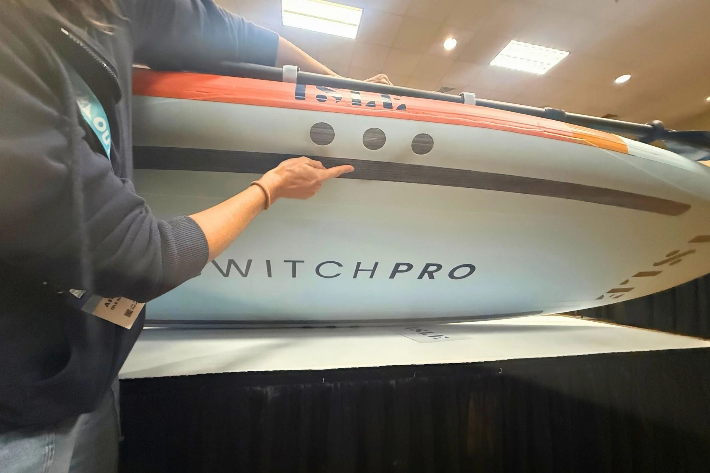 Person showing the bottom of a SUP board.
