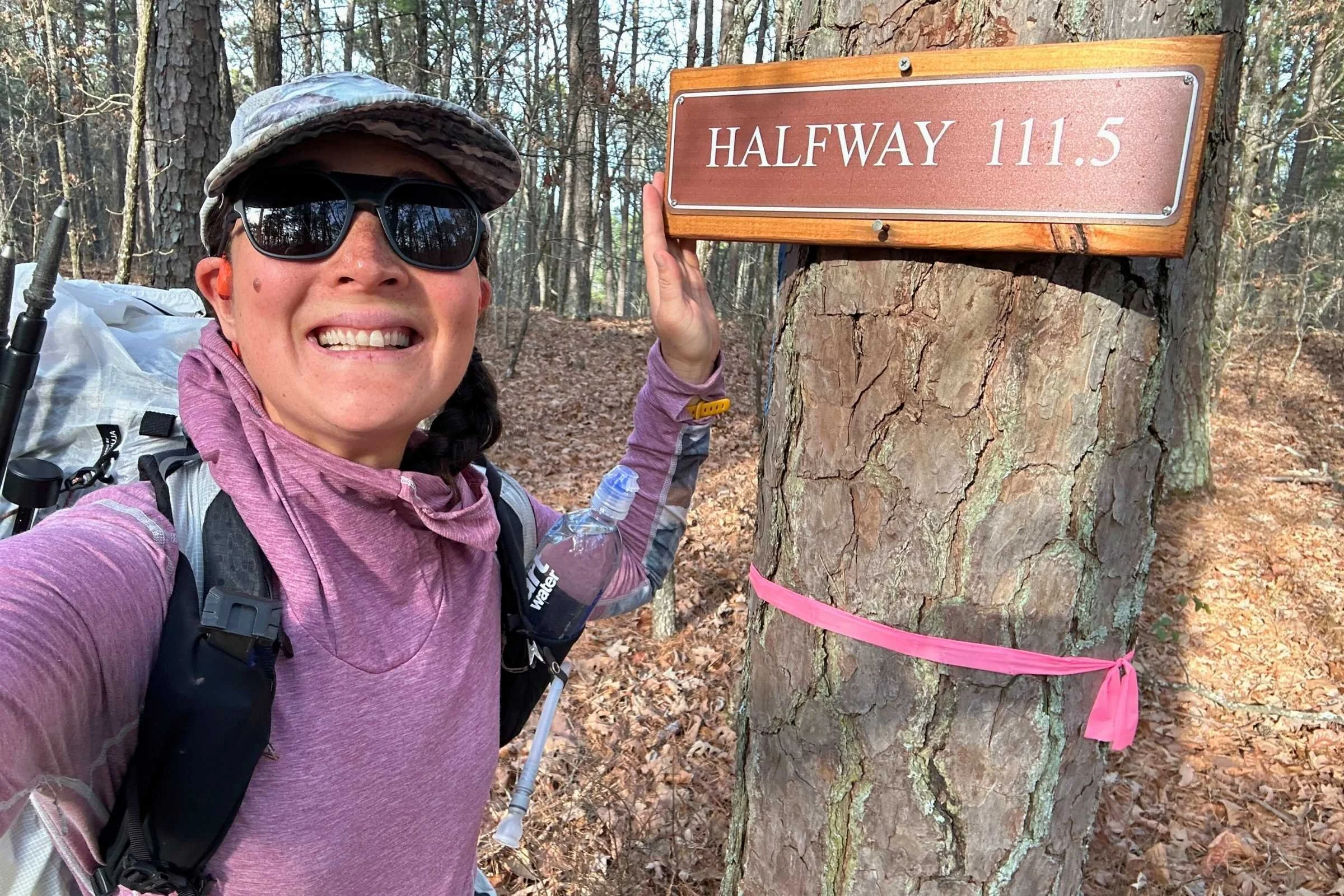 Liz celebrating at the Ouachita Trail halfway marker at mile 111.5