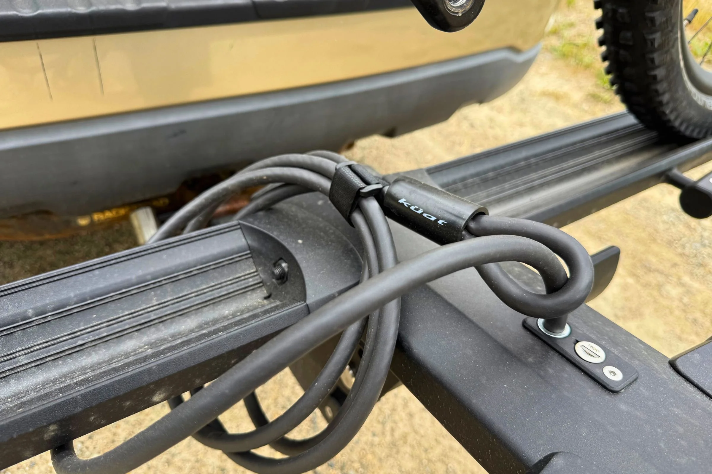 Integrated cable and hitch locks securing bikes to the rack