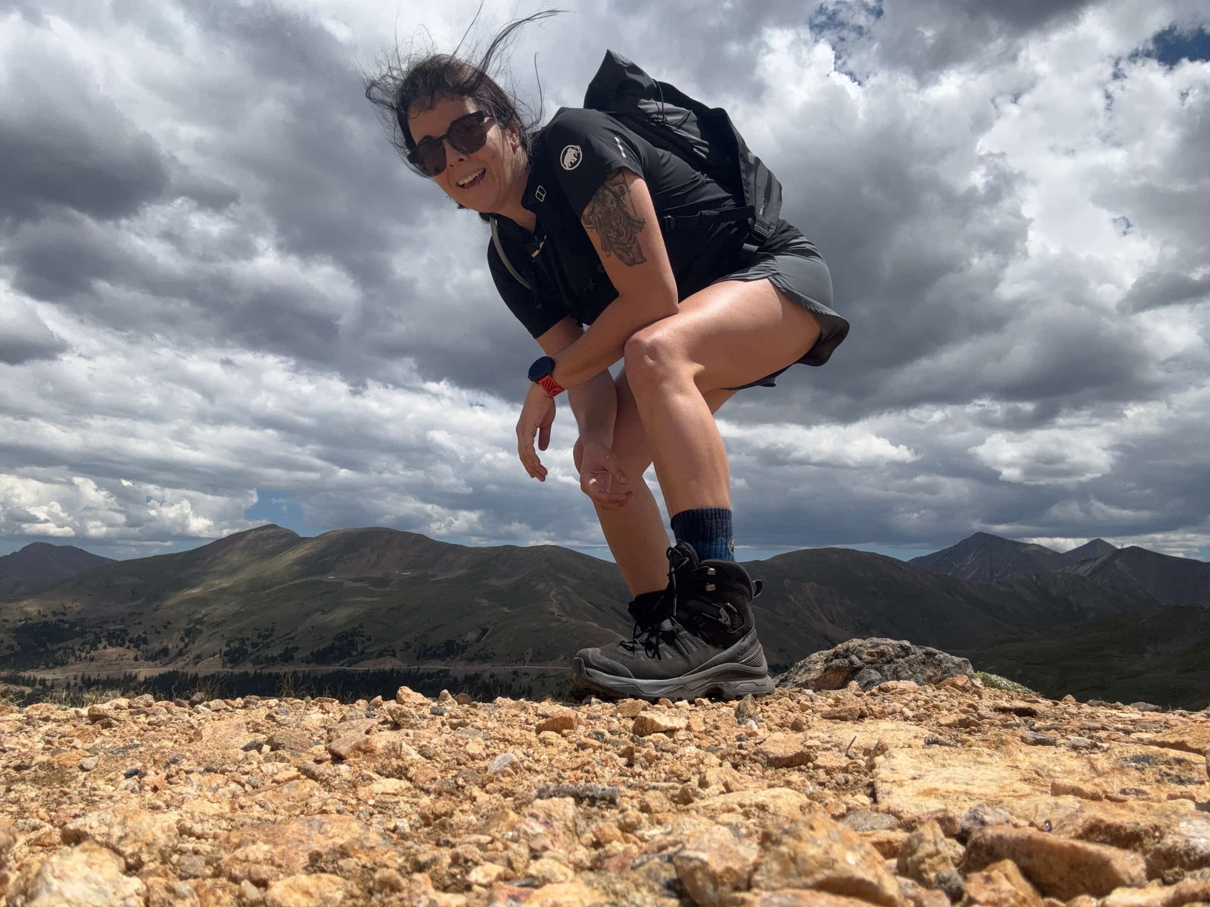 Mary Beth Skylis hiking in Salomon quest 5 boots above treeline in the wind