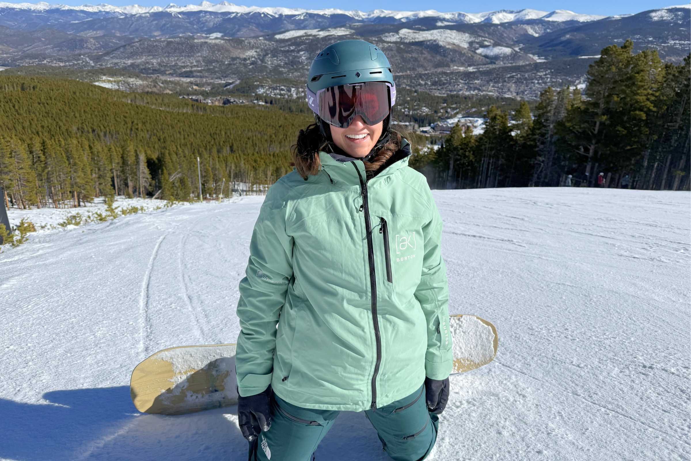Snowboarder wearing the mint green Burton [ak] Embark GORE-TEX 2L snowboarding jacket