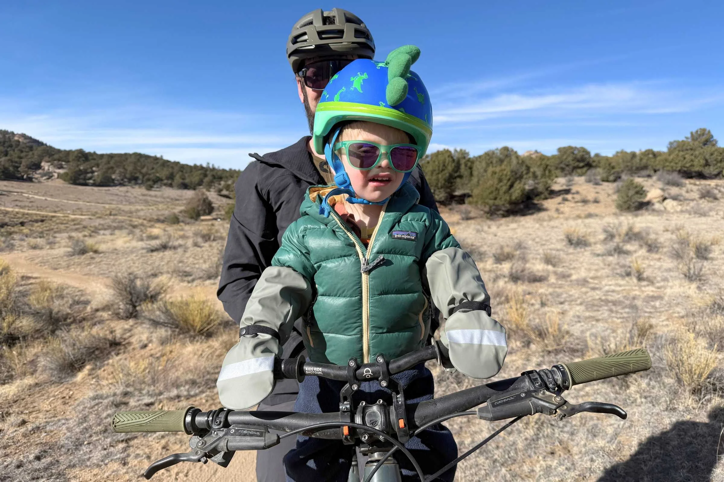 Toddler wearing Reima Puros waterproof gloves while biking