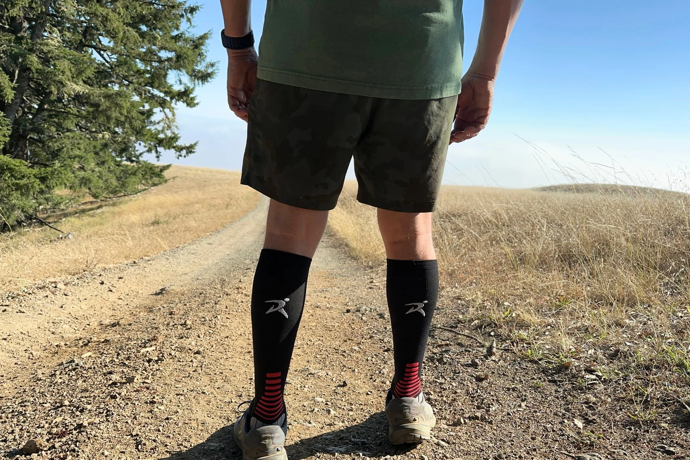 Tester on a dirt road in teh Rymora Compression Socks