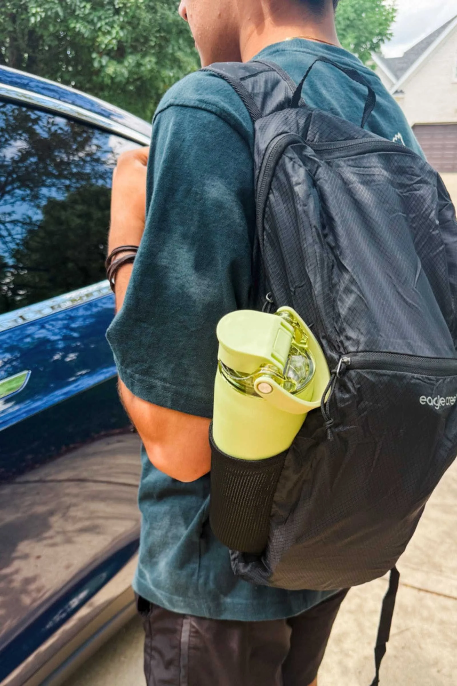 Eagle Creek Packable Backpack slung over a single shoulder with a water bottle in the side pocket