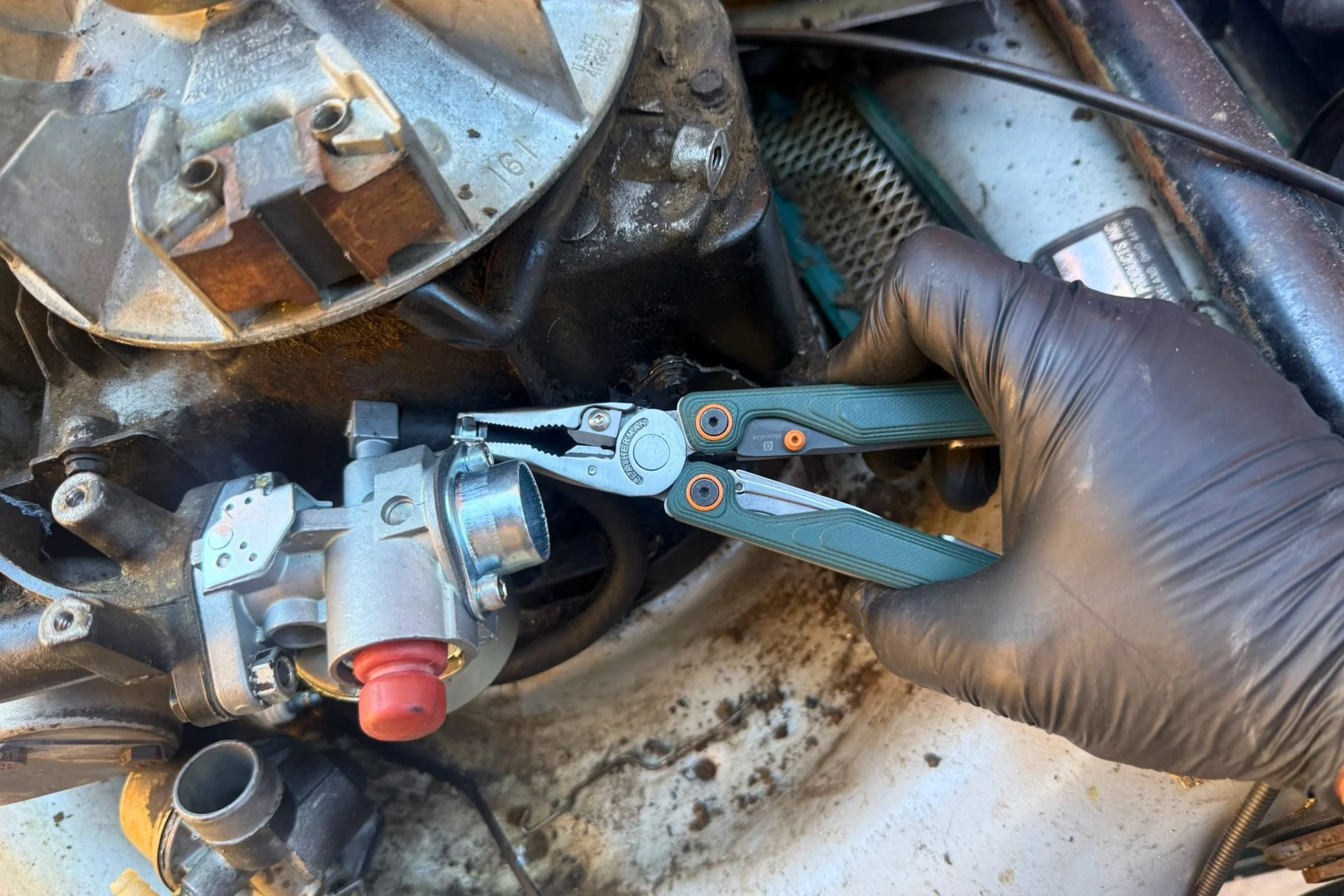The thin tips of the Leatherman Wave Alpha’s pliers made them great for getting into tight spaces like this to manipulate this spring hose clamp. Courtesy Chris Meehan
