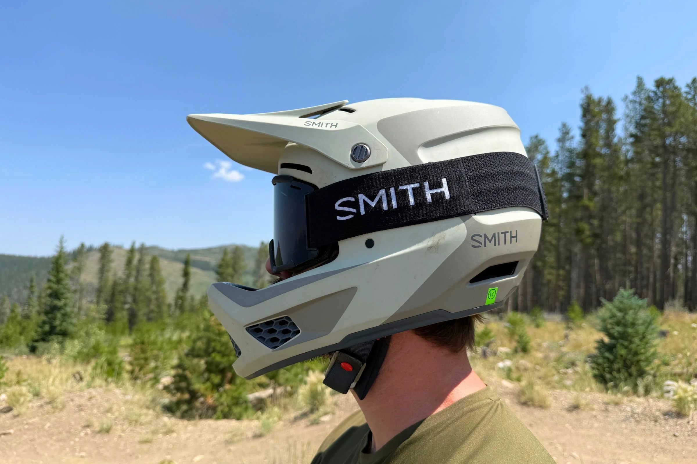 A side-profile view of a man wearing a Smith Hardline helmet outdoors.