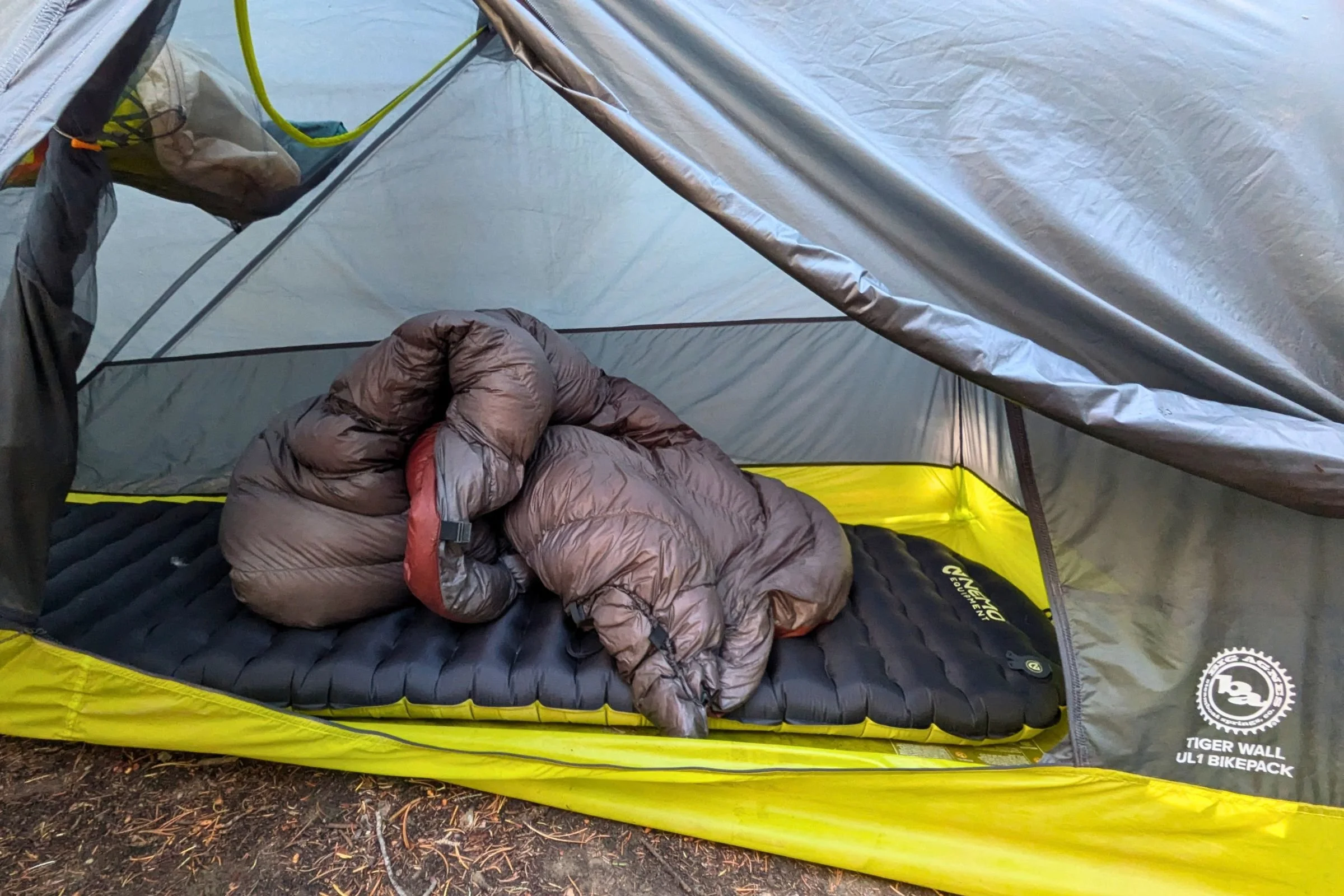The Big Agnes Tiger Wall UL1 Bikepack Tent with a NEMO sleeping pad and down sleeping quilt.