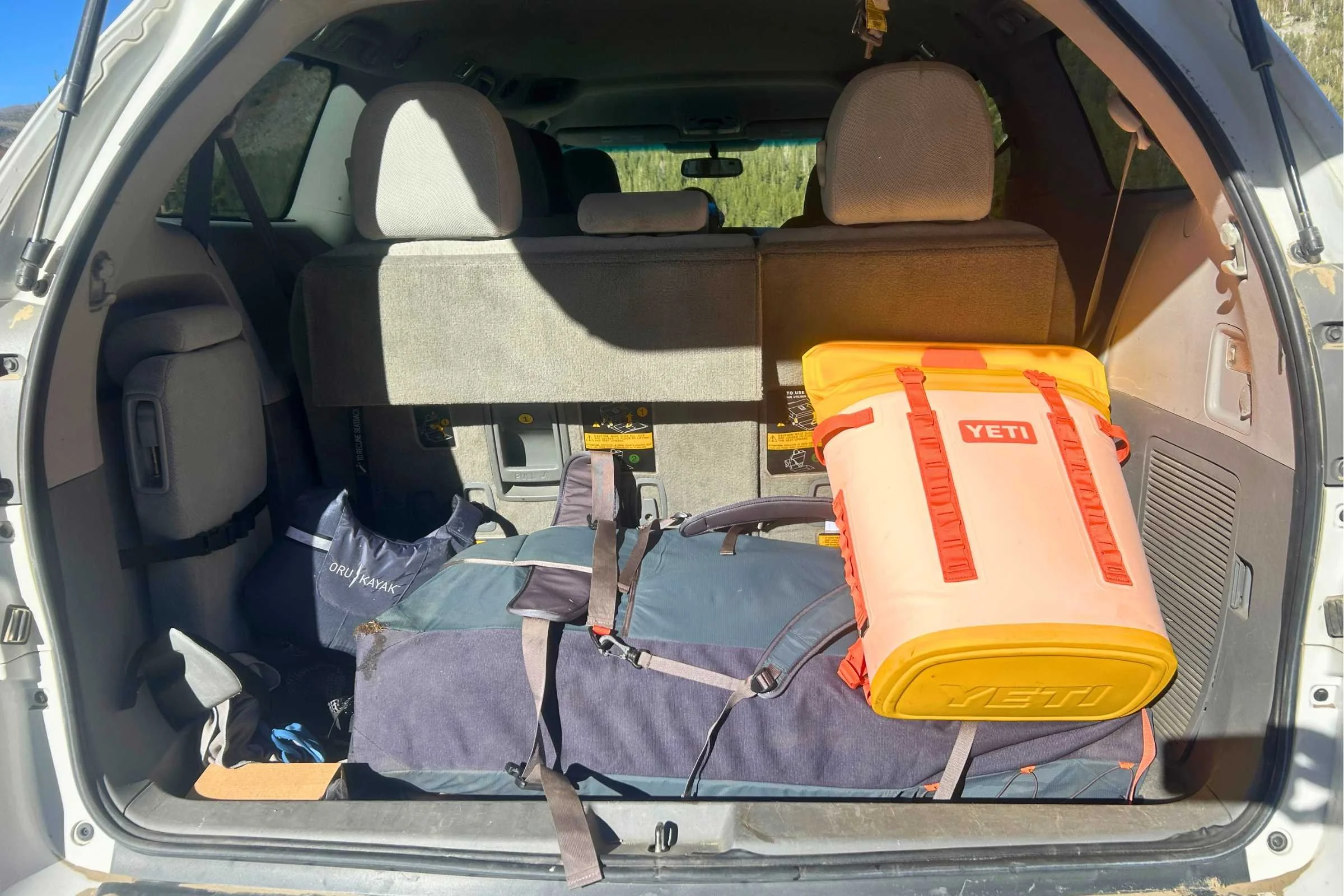 The YETI backpack cooler in the back of my vehicle alongside other gear. Despite a lot of use, it is so easy to clean that it looks practically new (which is better than can be said for my car).