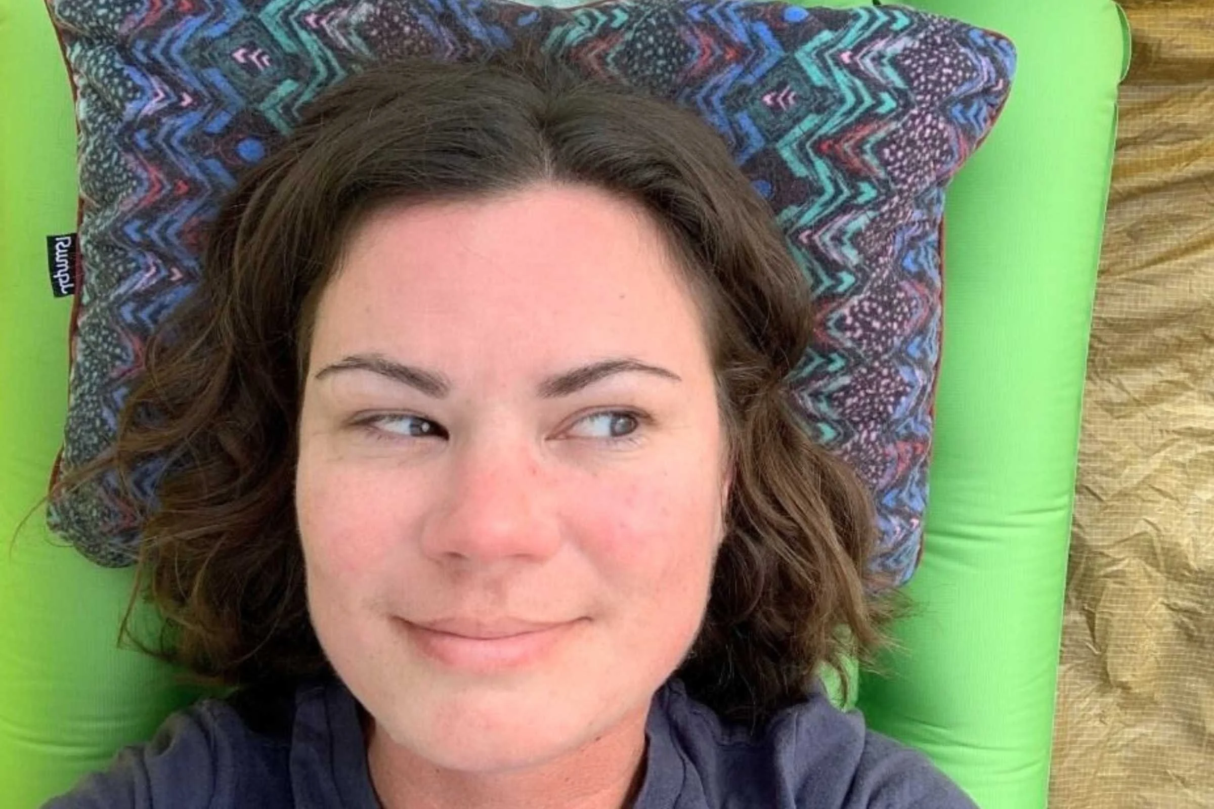 Camper using Rumpl Stuffable Pillowcase as part of their sleep system