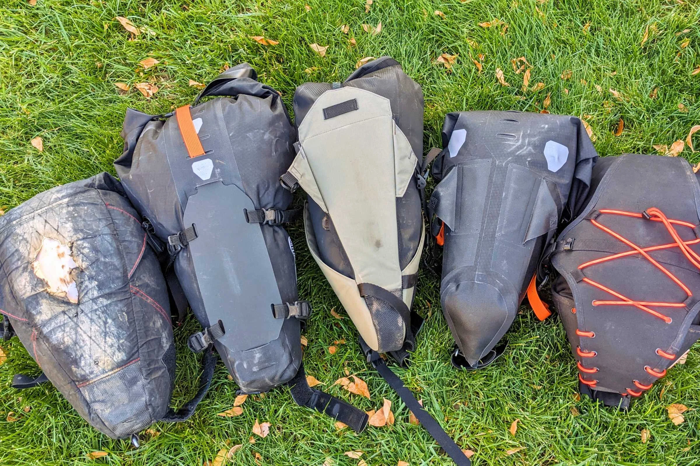 All the larger saddle bags we tested are made of durable materials since they will rub on your tire at some point, as you can see from the 7-year-old Revelate Viscacha on the far left that's buzzed its fair share of rear tires.