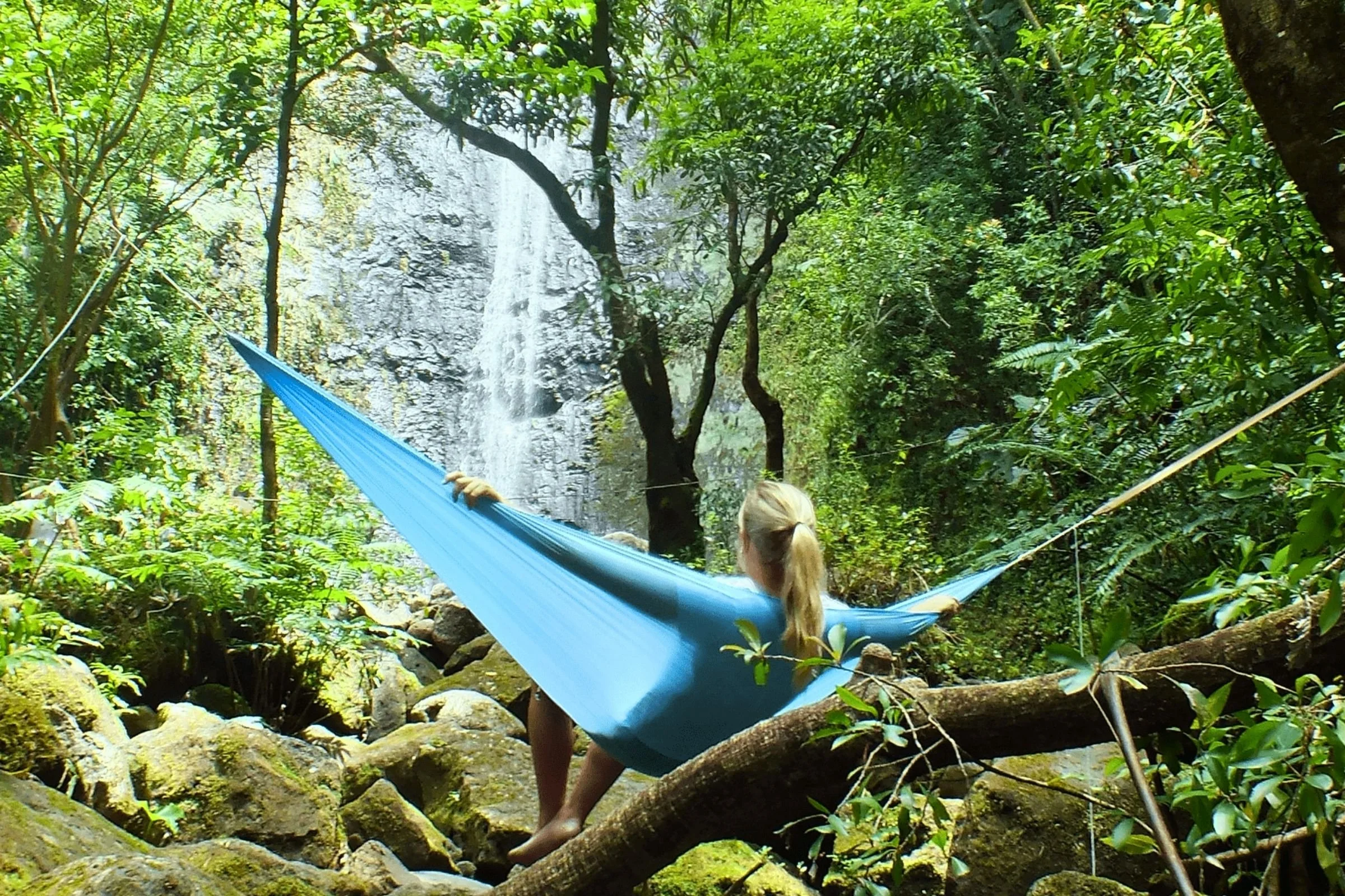 To test these hammocks, non-expert testers helped us gauge ease of use and setup, and expert testers compared technical features across different hammocks. Image shows tester lounging in a hammock watching a waterfall.