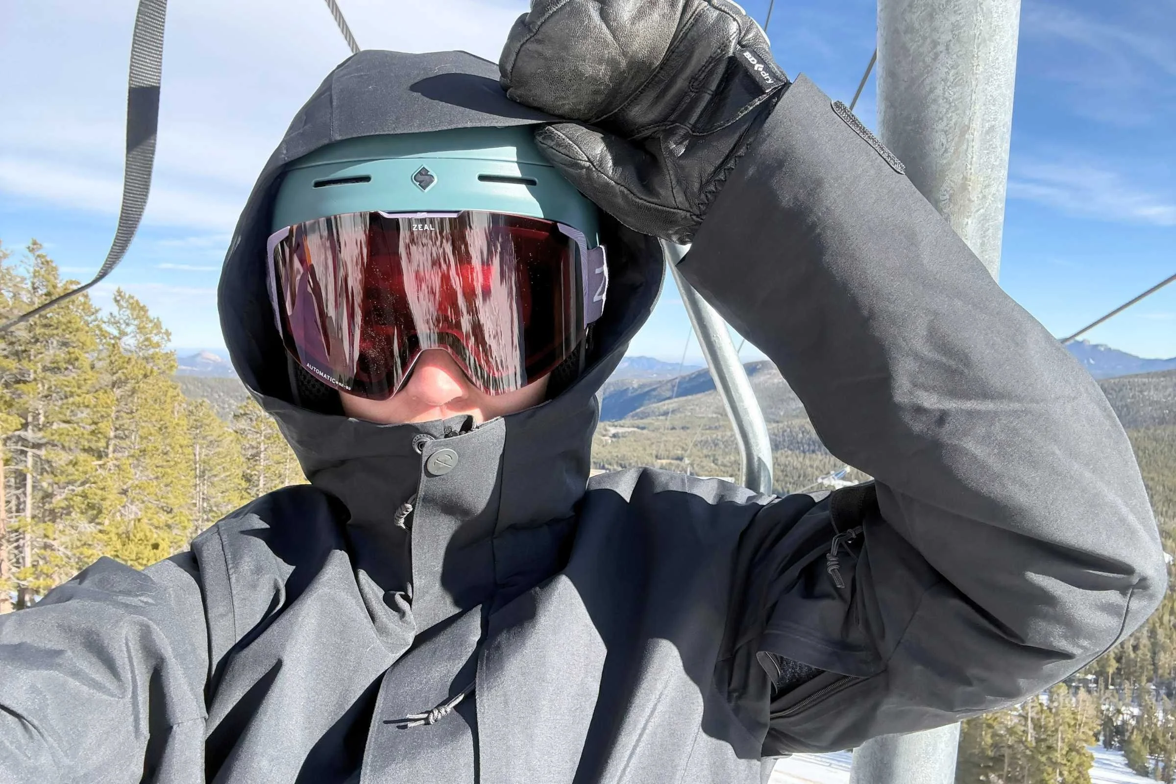 Snowboarder wearing REI Co-op Powderbound Insulated snowboard jacket riding on a snowy mountain slope