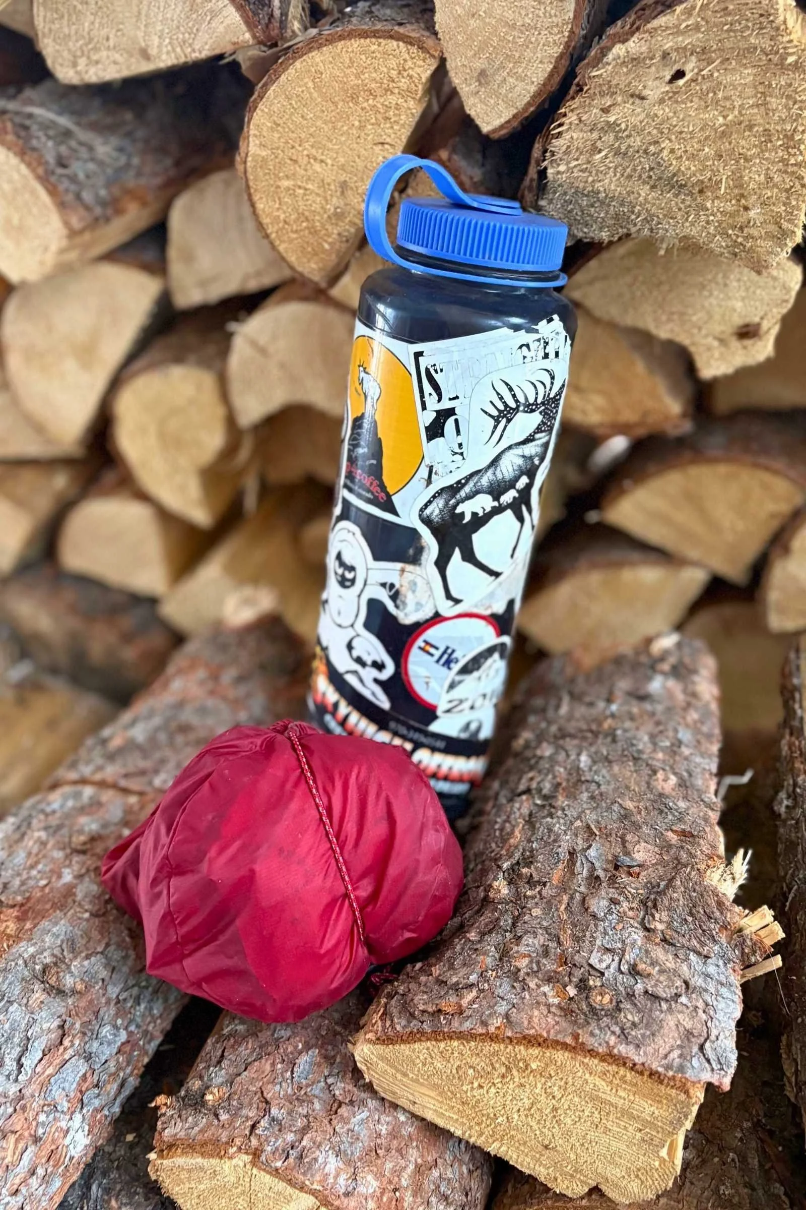 packed up ghosts in a red bag next to a nalgene