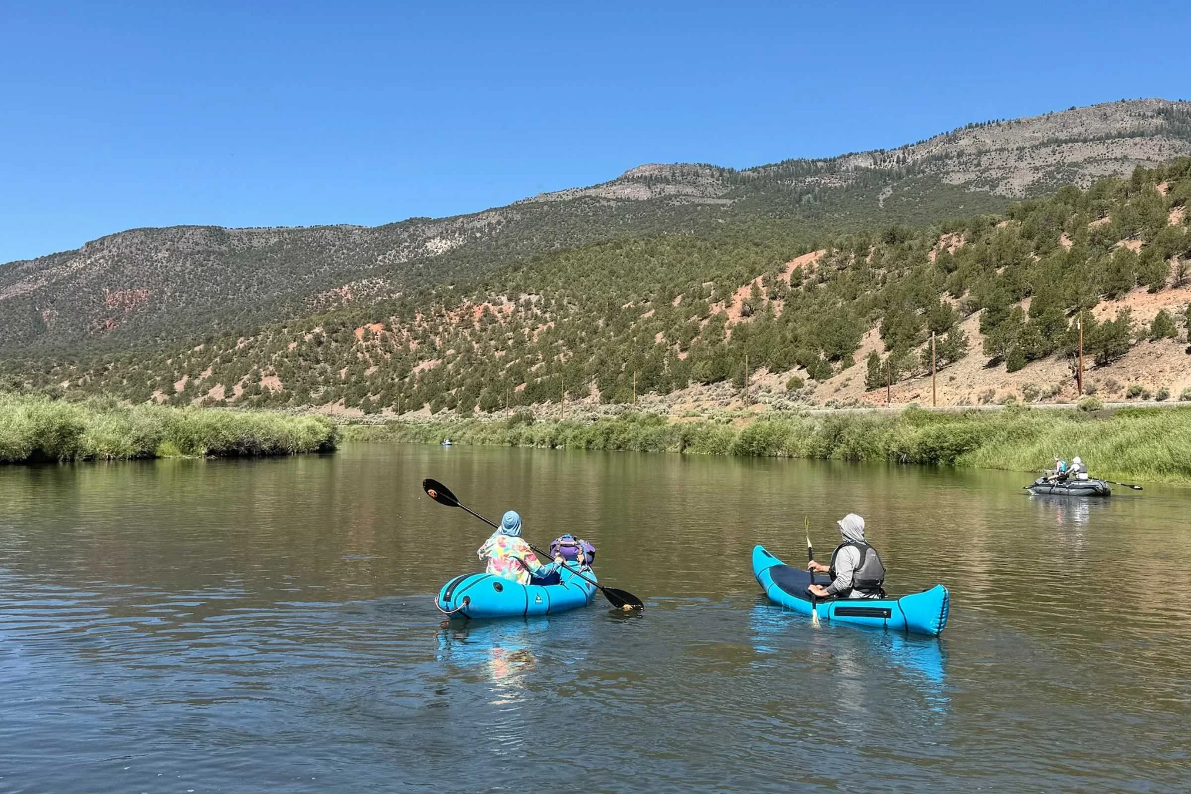 The Alpacka Chinook on the right is designed for flatwater, like this section of the Colorado River, while the Alpacka Gnarwhal on the left is designed for faster water. Courtesy Chris Meehan