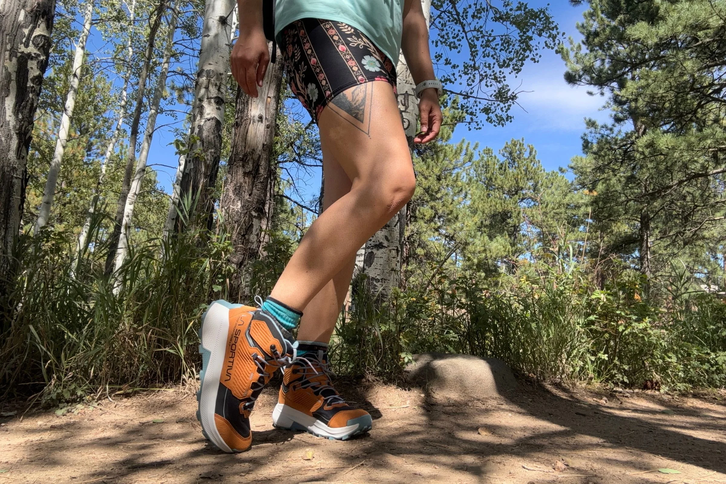 Woman wearing orange La Sportiva Prodigio Hike LT GTX hiking boots on a sunny day.