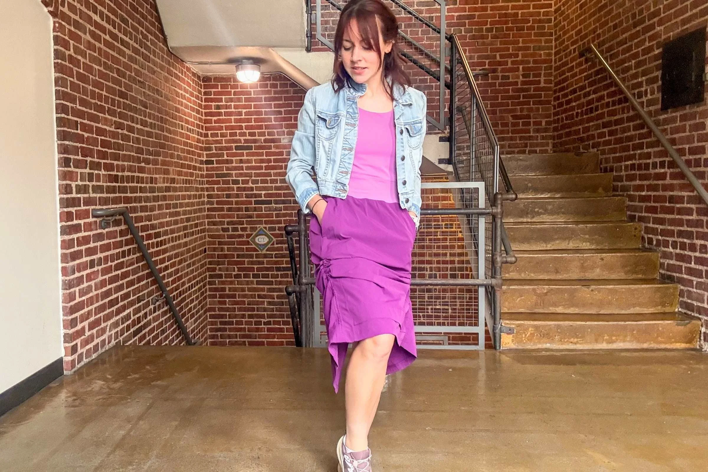 Woman showing off the cinched hem on the Title Nine Limitless Midi Dress