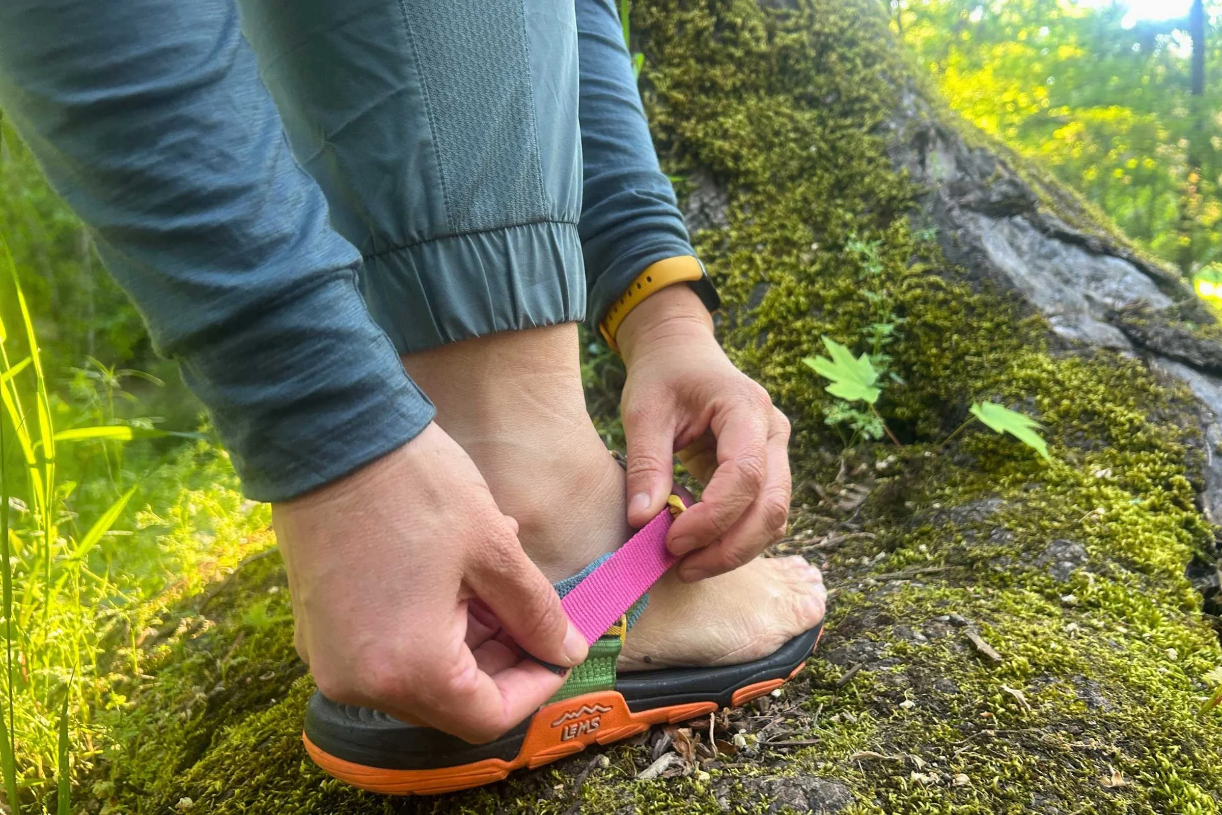 Close-up pf tightening the Lems Switchback Sandal Knit