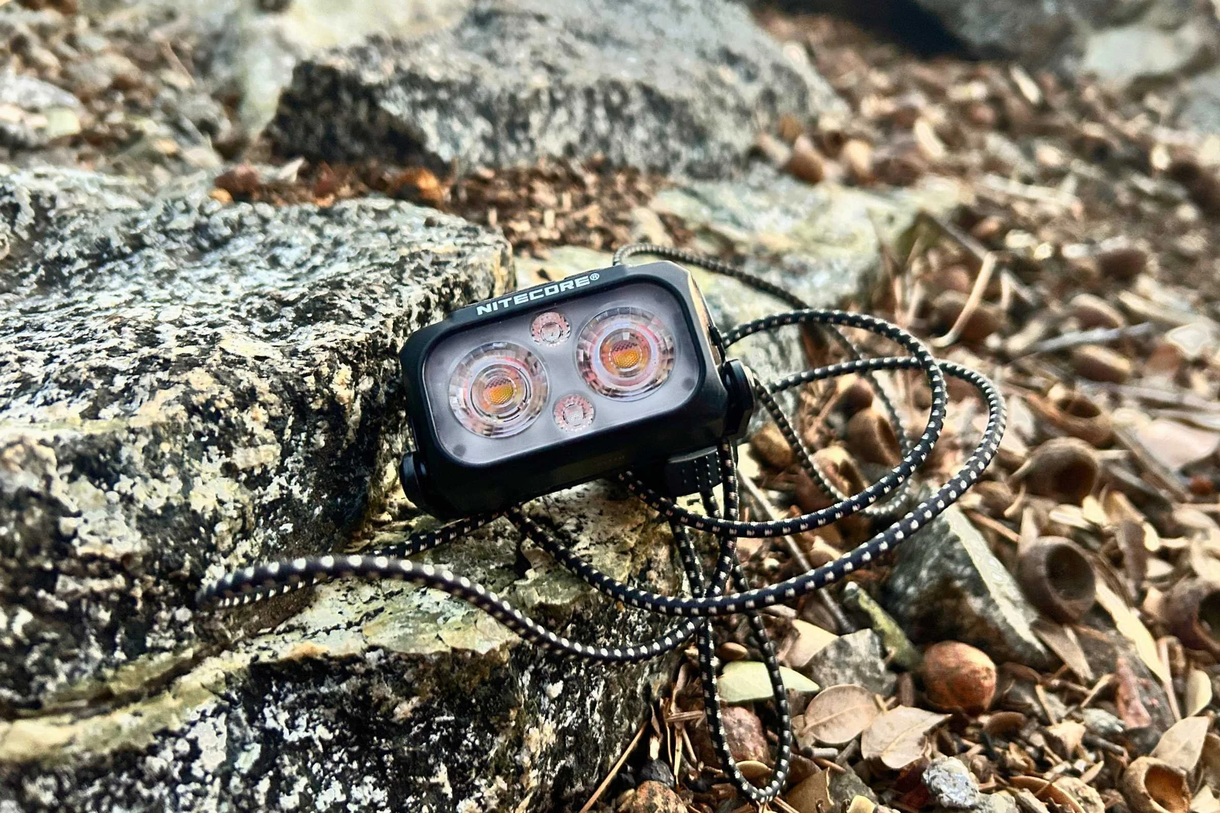 Nitecore NU25 MCT displayed on rocks