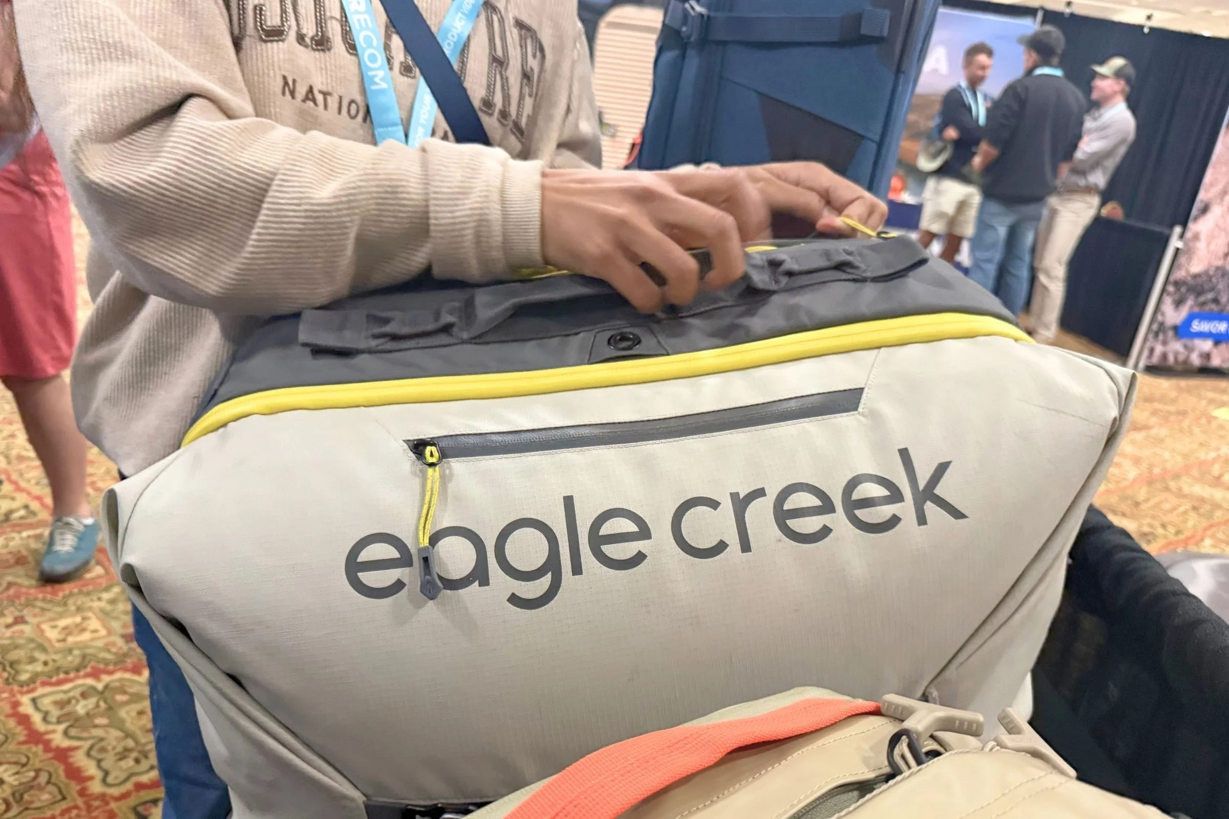 A man holds an Eagle Creek bag at the 2026 Outdoor Media Summit.