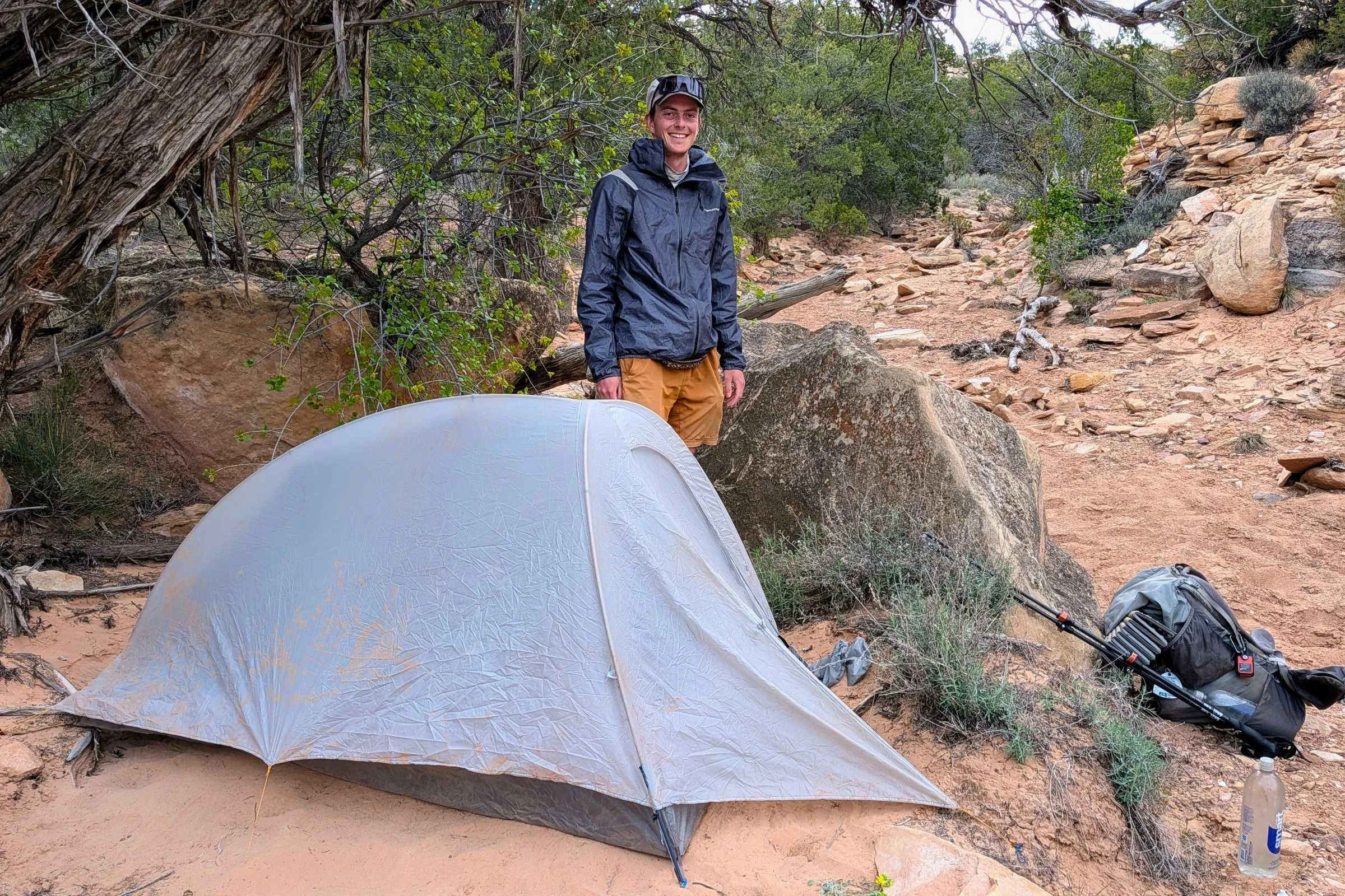Mountain Hardwear Nimbus UL tent side view in the desert with backpacker behind it