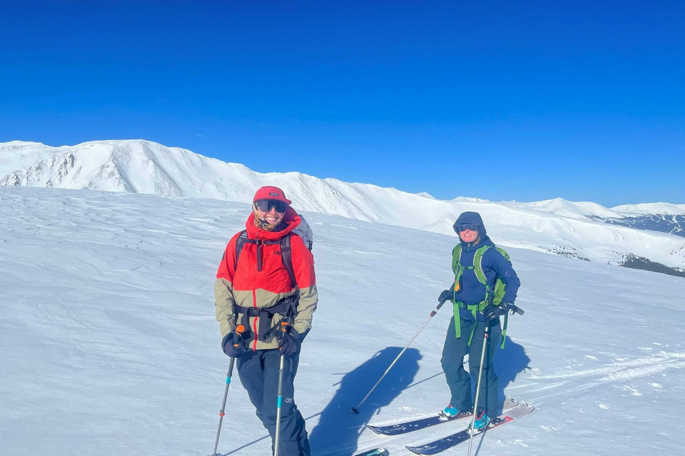 two skiers testing ski poles