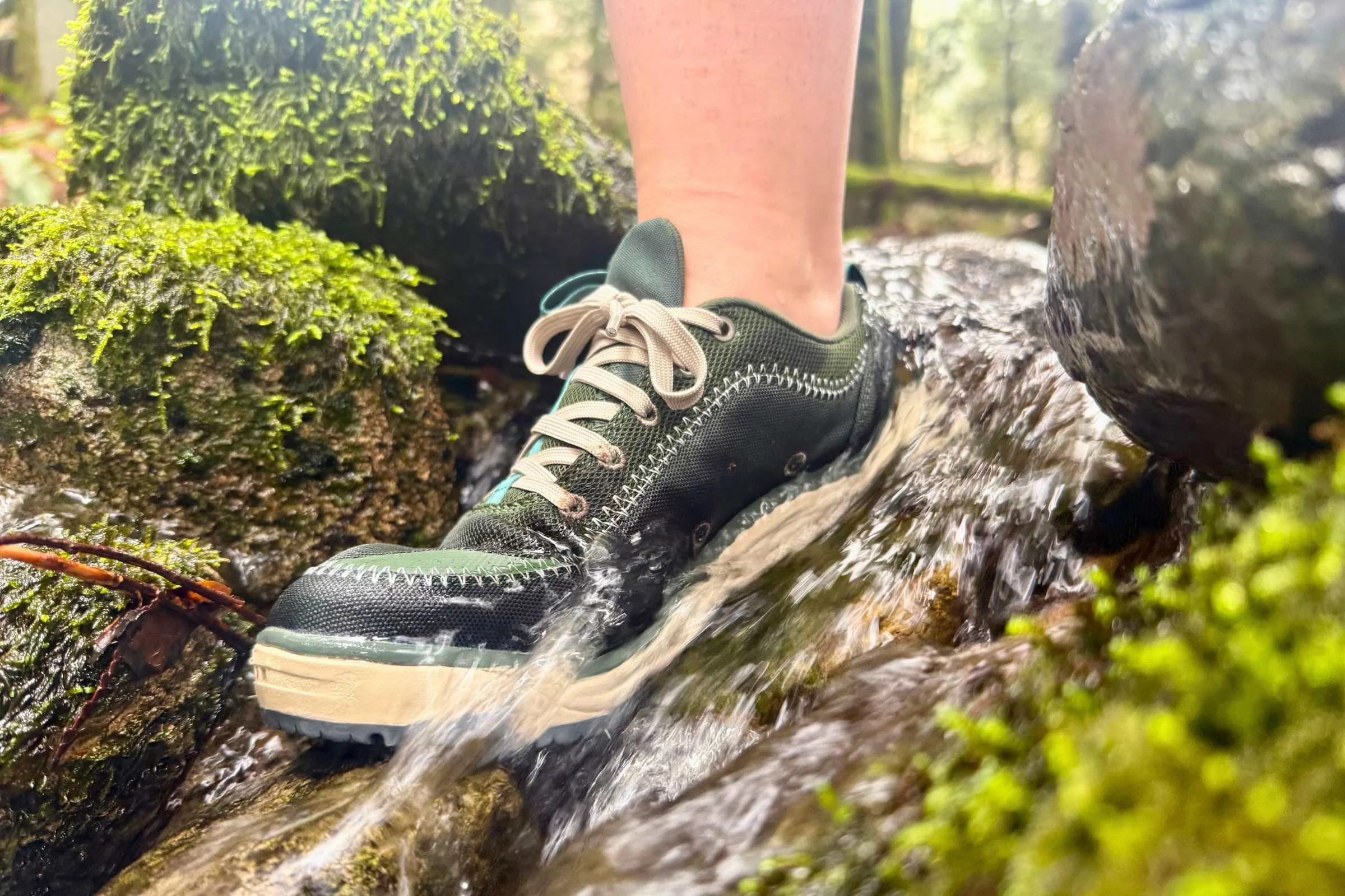 Person wearing water shoes standing in river