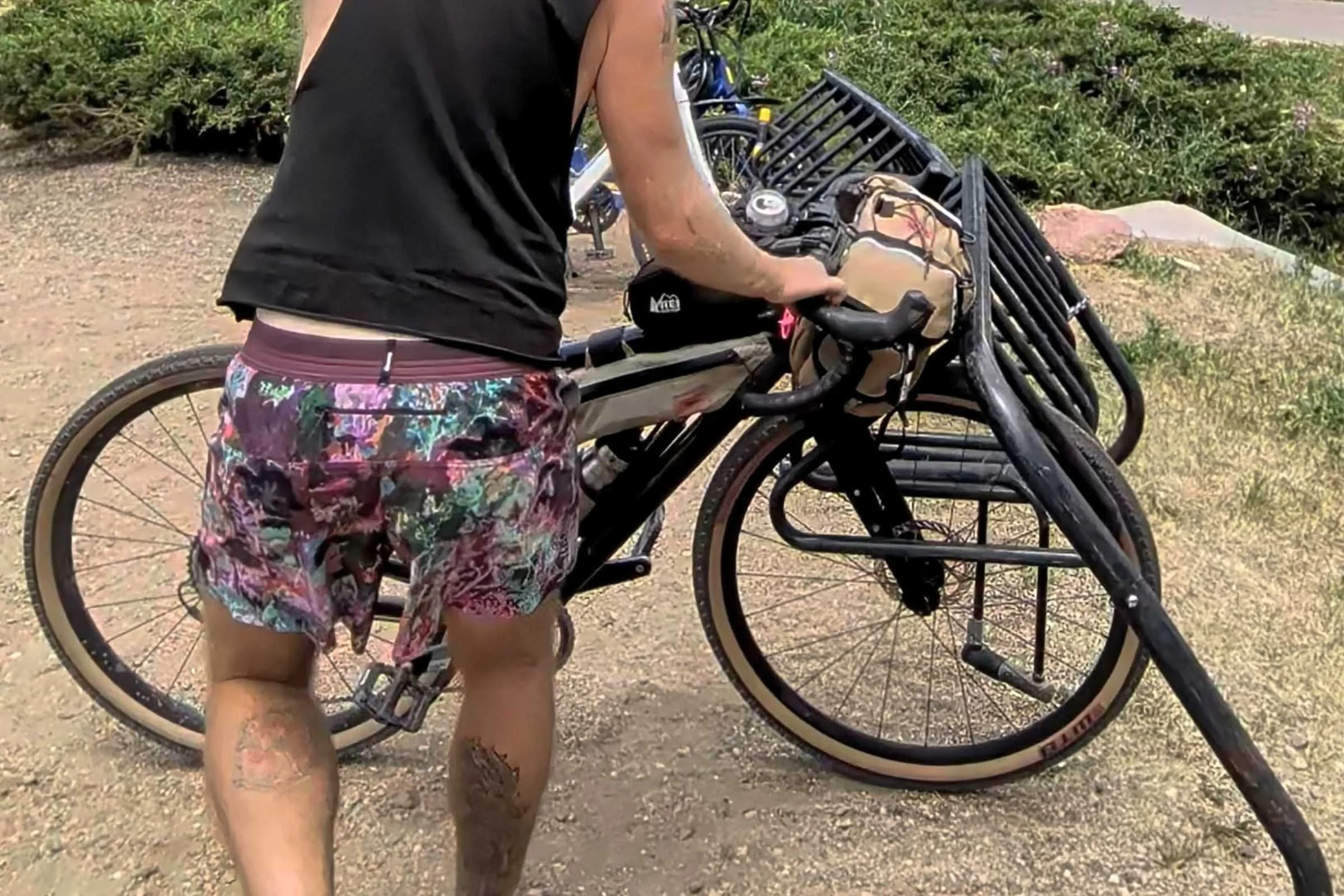 loads a bicycle with a basket outdoors with Janji AFO Middle Running Shorts
