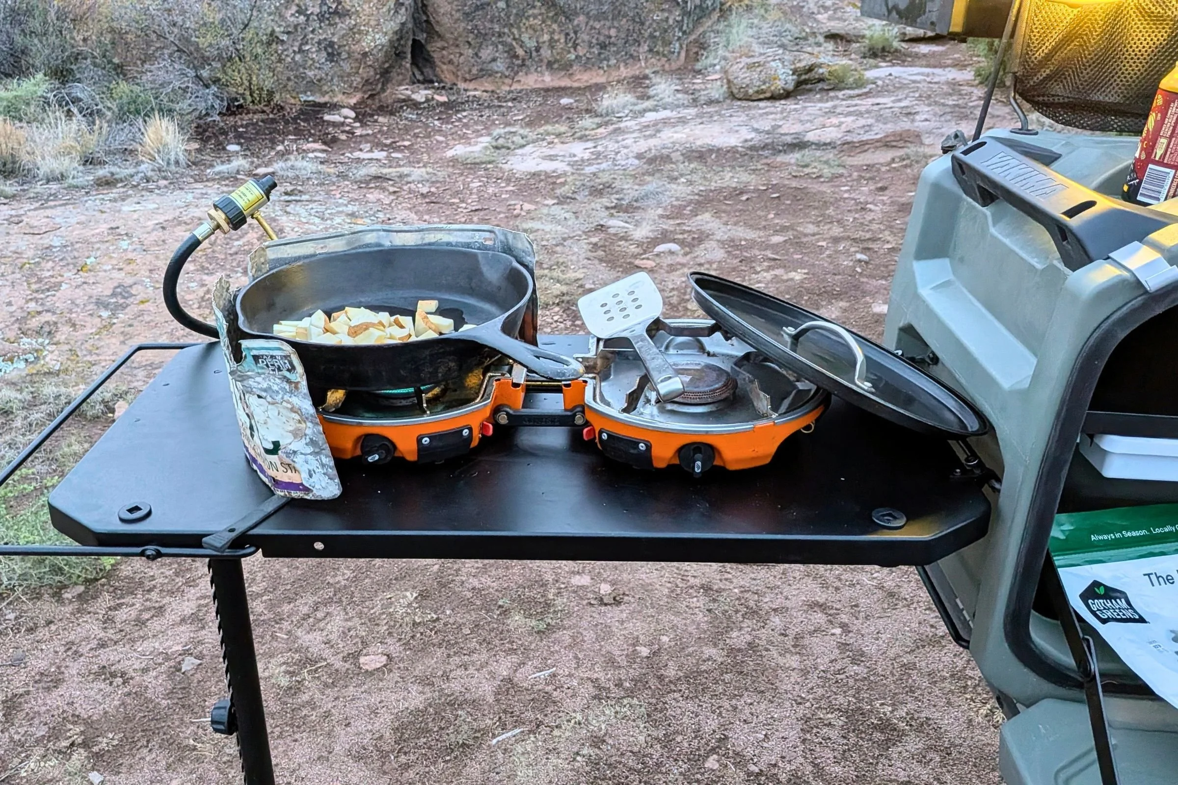 Yakima EXO OpenRange side cook table arranged with pots and pans for meal preparation.