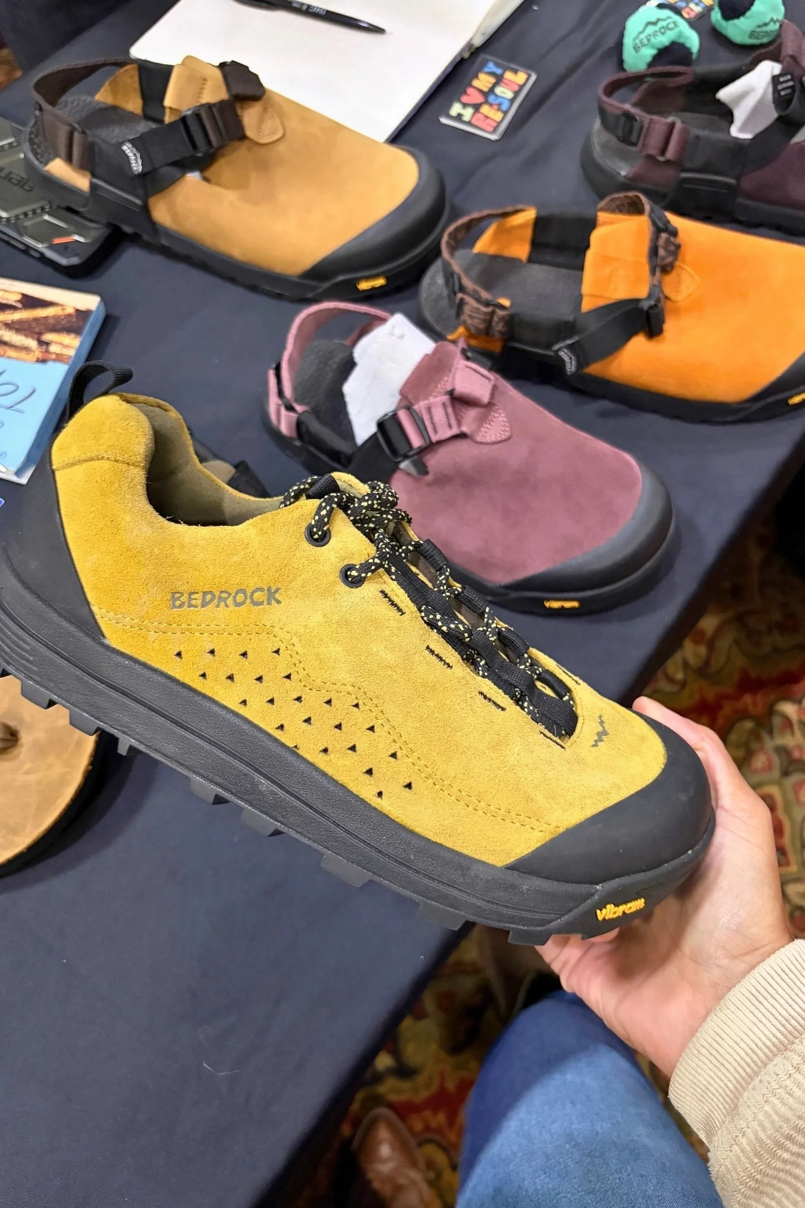Person holding Yellow Bedrock shoes.