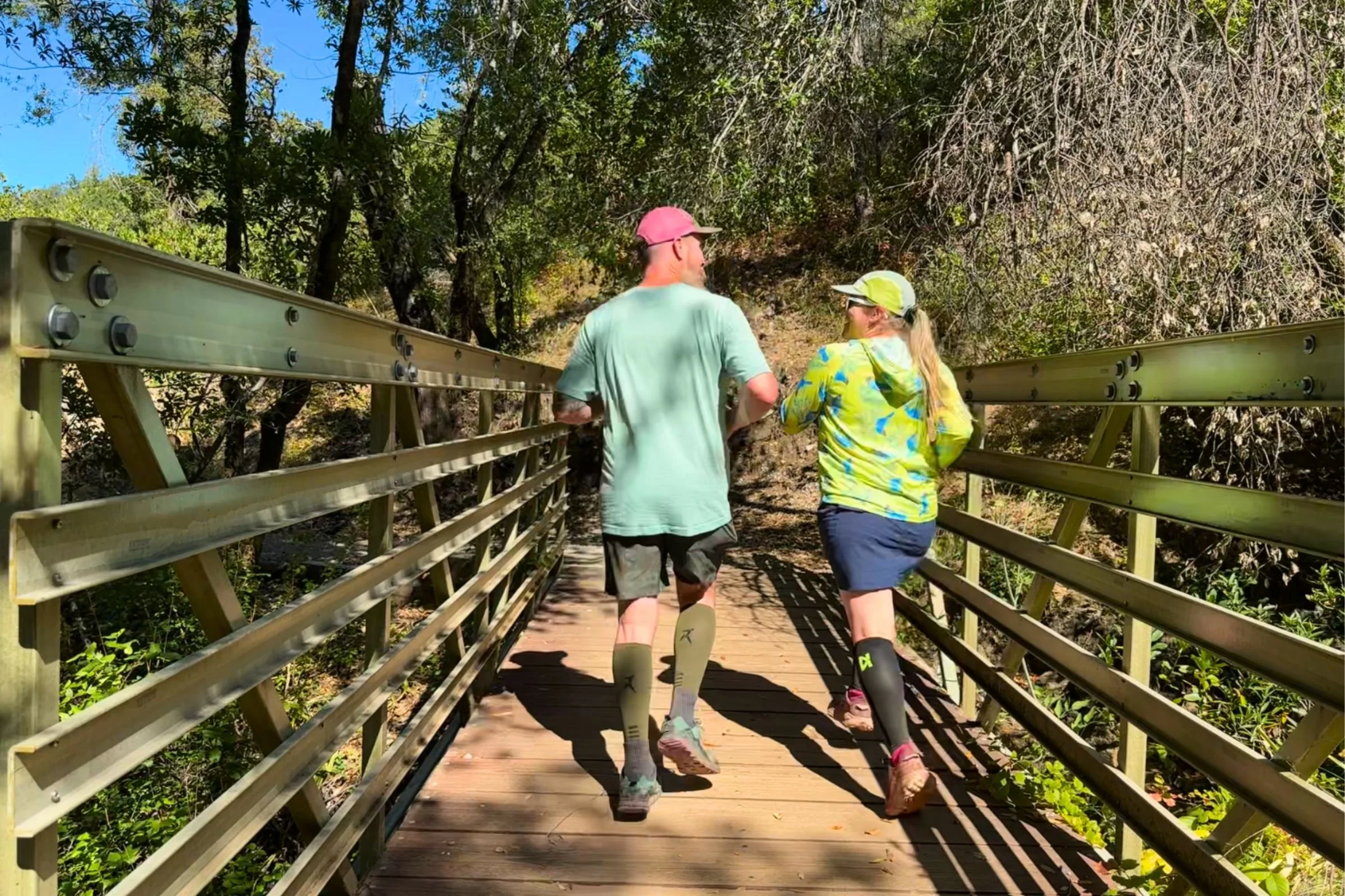 jogging along a wooden walkway while testing cal compression sleeves