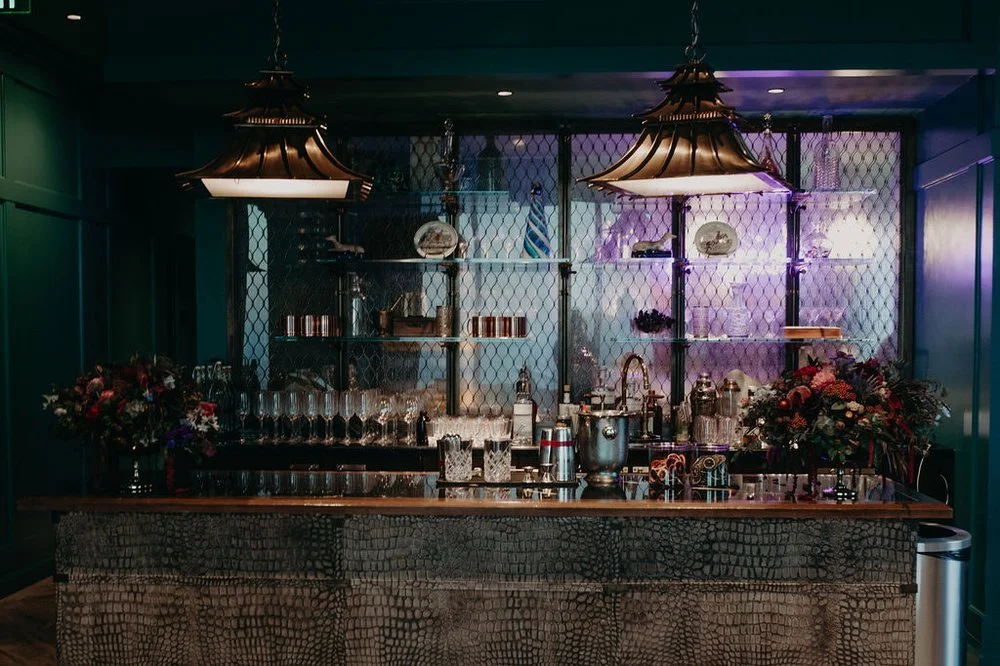 Moody dark bar san Francisco custom party setup with bespoke Glassware copper lighting snakeskin barfront