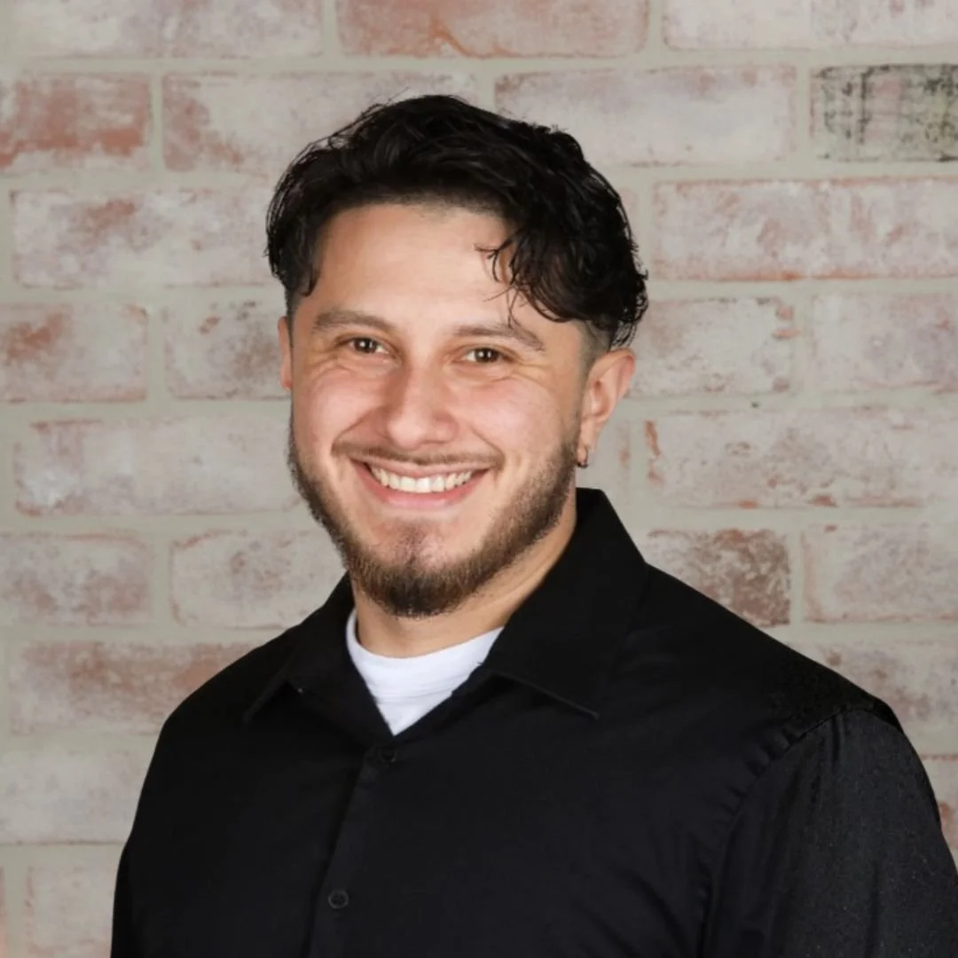Mobile Mixologist Lead Bartender Marcos in front of a white brick wall