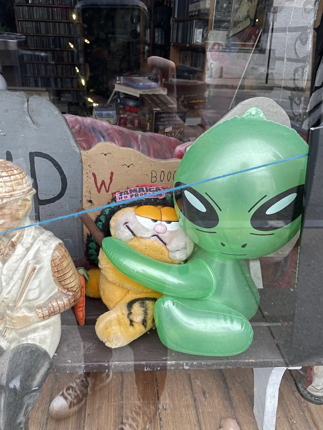 inflatable alien hugging a plush garfield