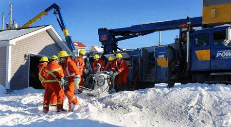 Power crews restore damaged lines in Newfoundland, Canada, 2014. (Photo: Globe &amp; Mail).
