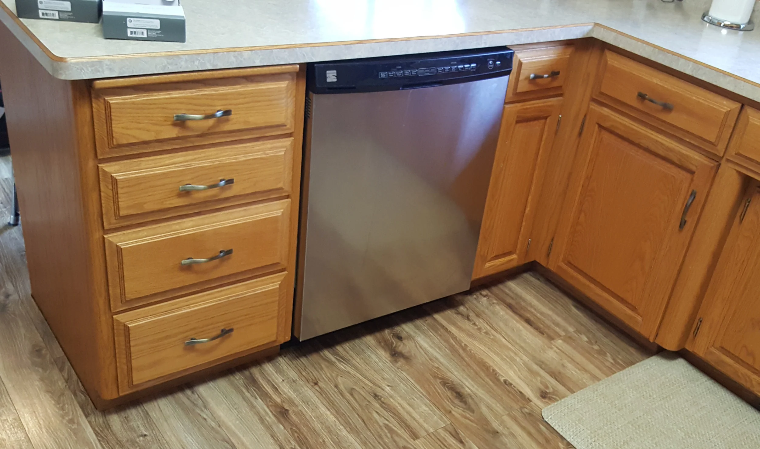 In this before photo you can see the dated honey oak, exposed hinges and dated pull hardware.