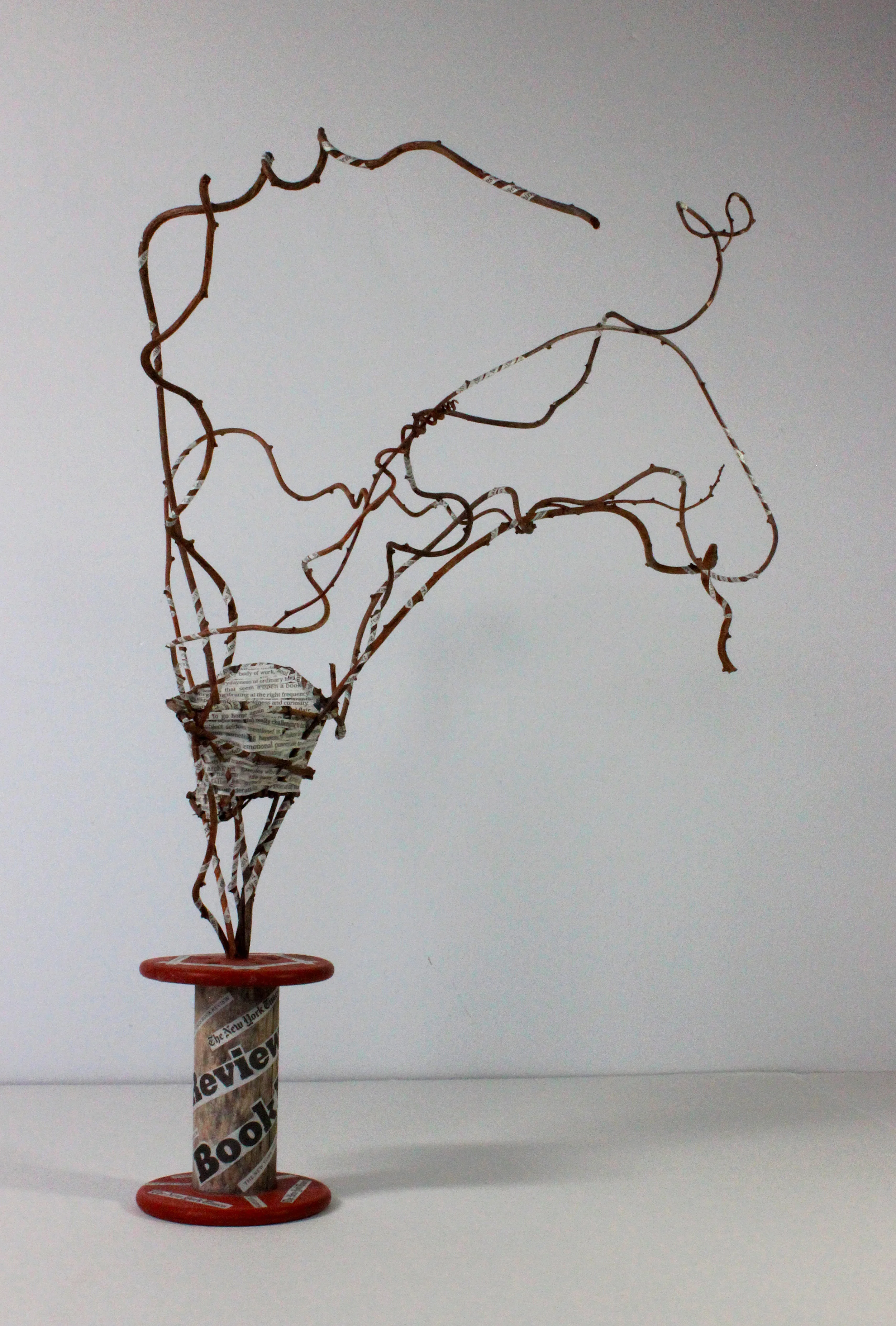 Nest VIII - Sunday: Vintage spool, found sticks, strips cut from Sunday New York Times Book Review. (15" tall)