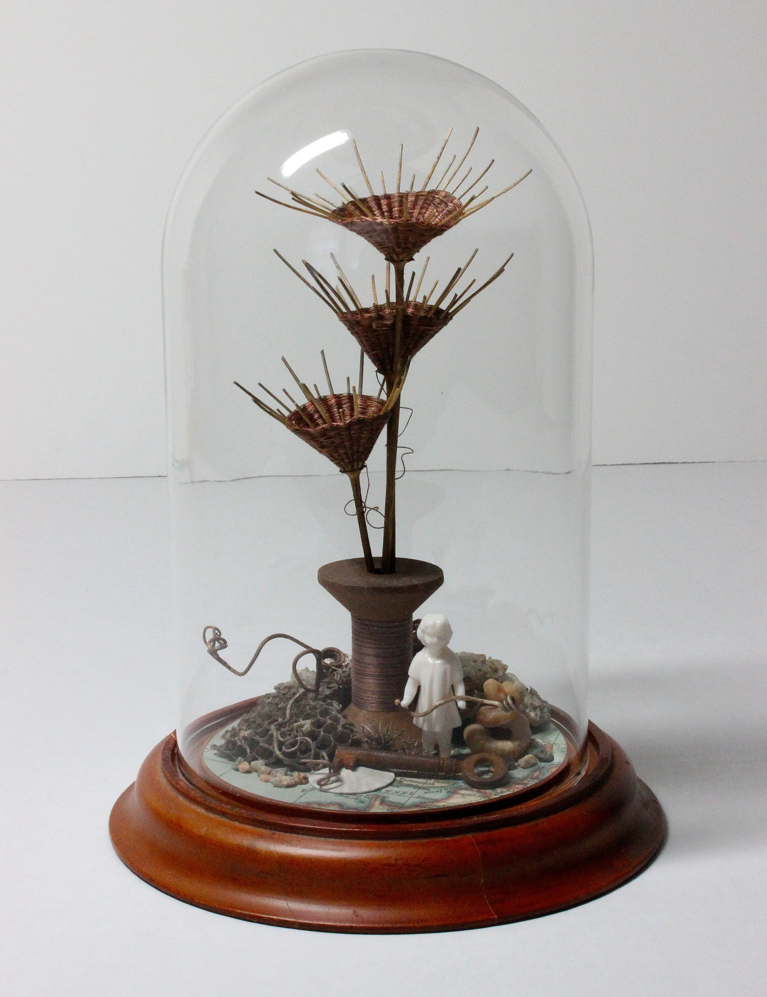 Young Anne: Wooden spool, embroidery thread, found objects, dried Queen Anne's Lace stems & umbrels, wooden base, glass dome. (9" tall)